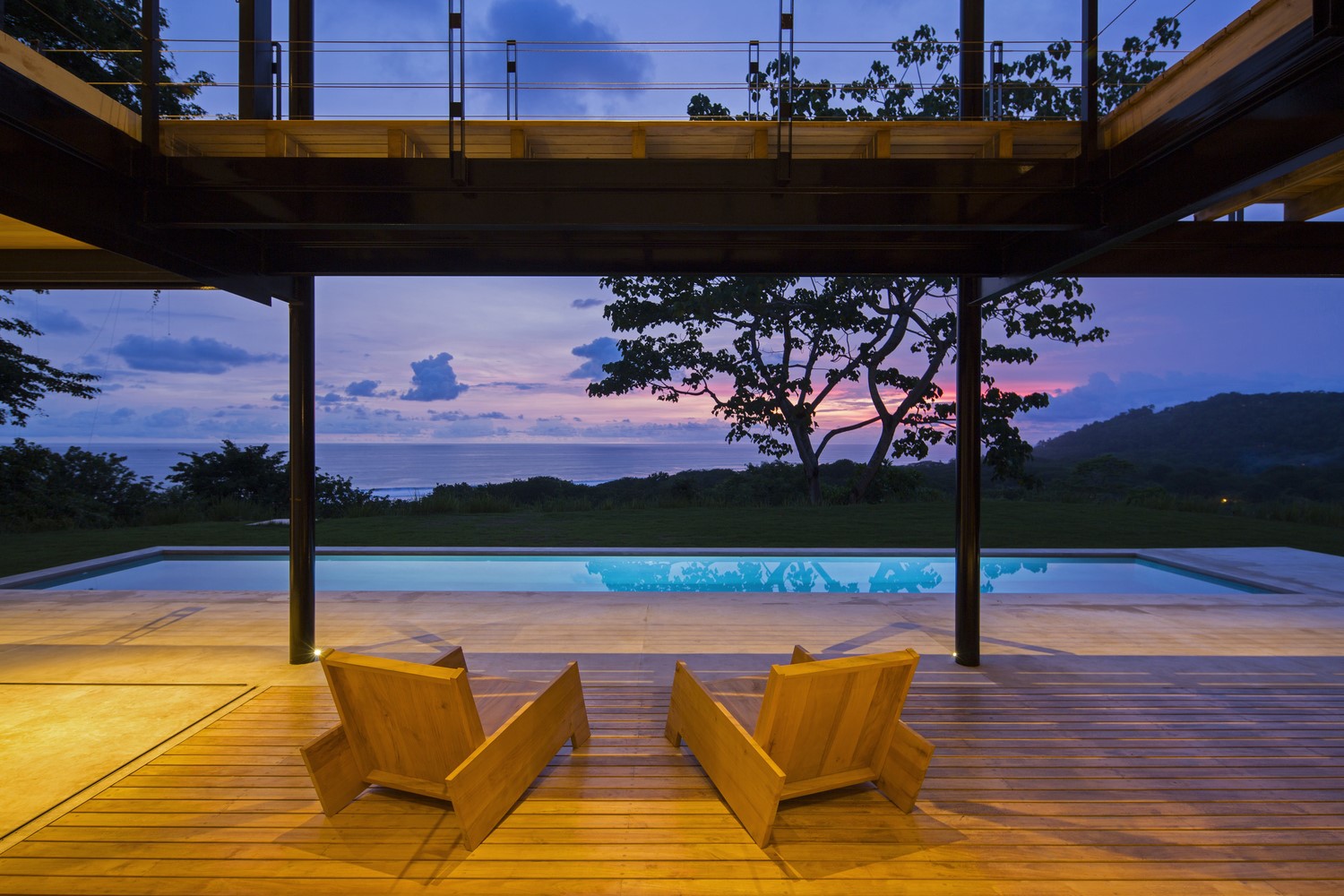 Modern house with swimming pool and ocean view at dusk HD Wallpaper