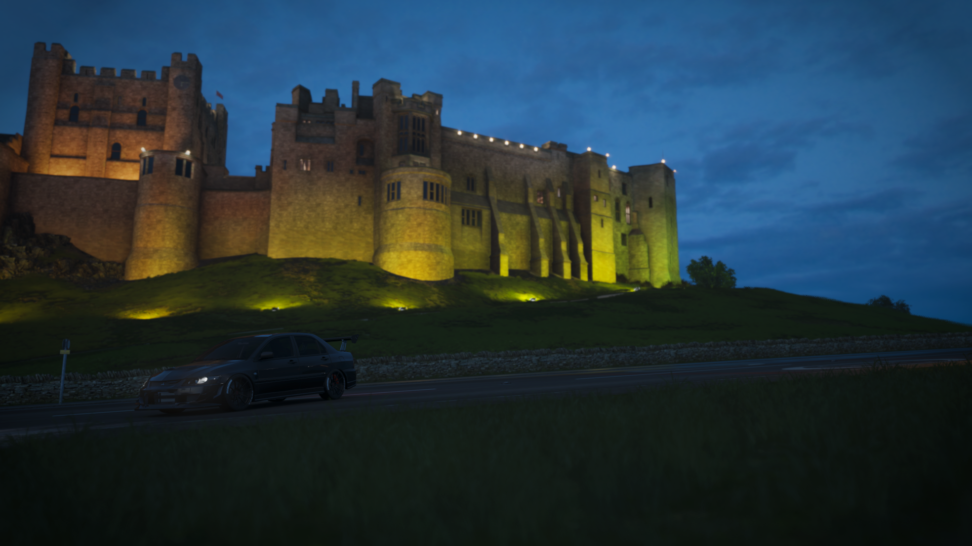 Mitsubishi Lancer EVO in front of illuminated castle at dusk HD Wallpaper