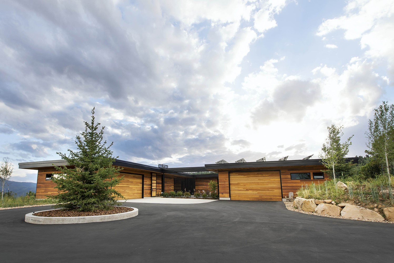 Modern luxury house with wooden facade and solar panels HD Wallpaper