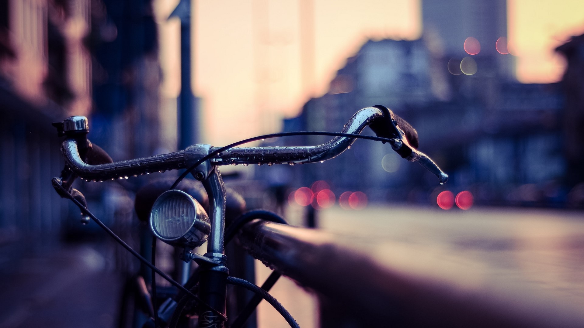 Bicycle handlebars with raindrops on a street HD Wallpaper