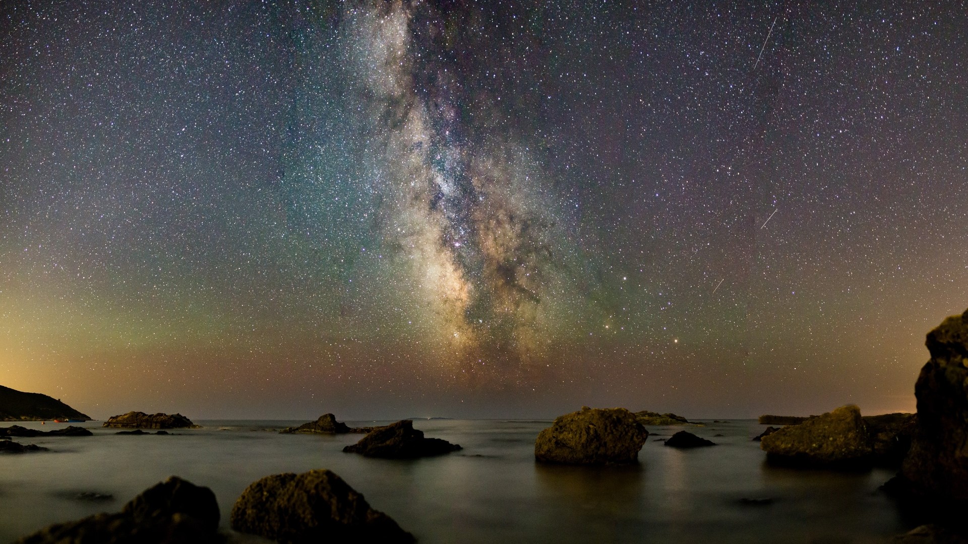 Milky Way over rocky coast at night HD Wallpaper