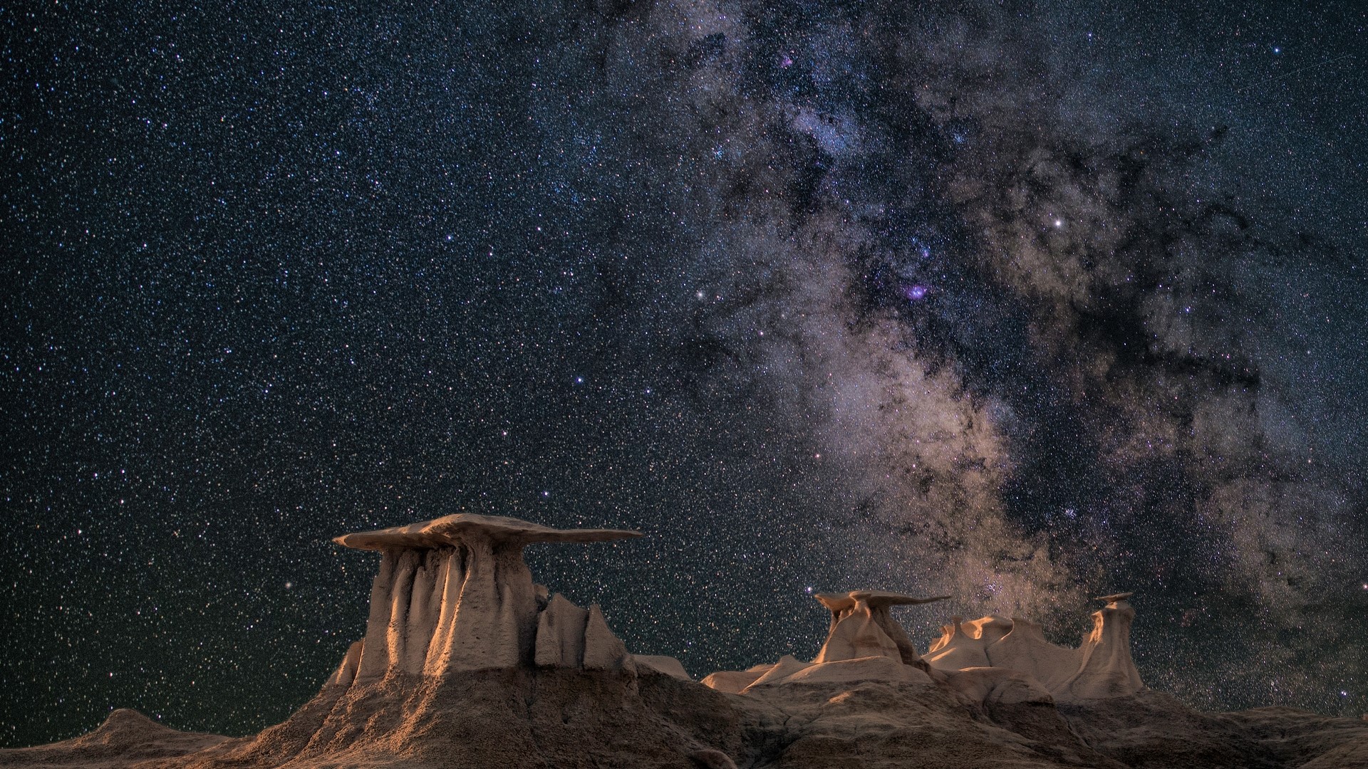 Milky Way over desert rock formations HD Wallpaper