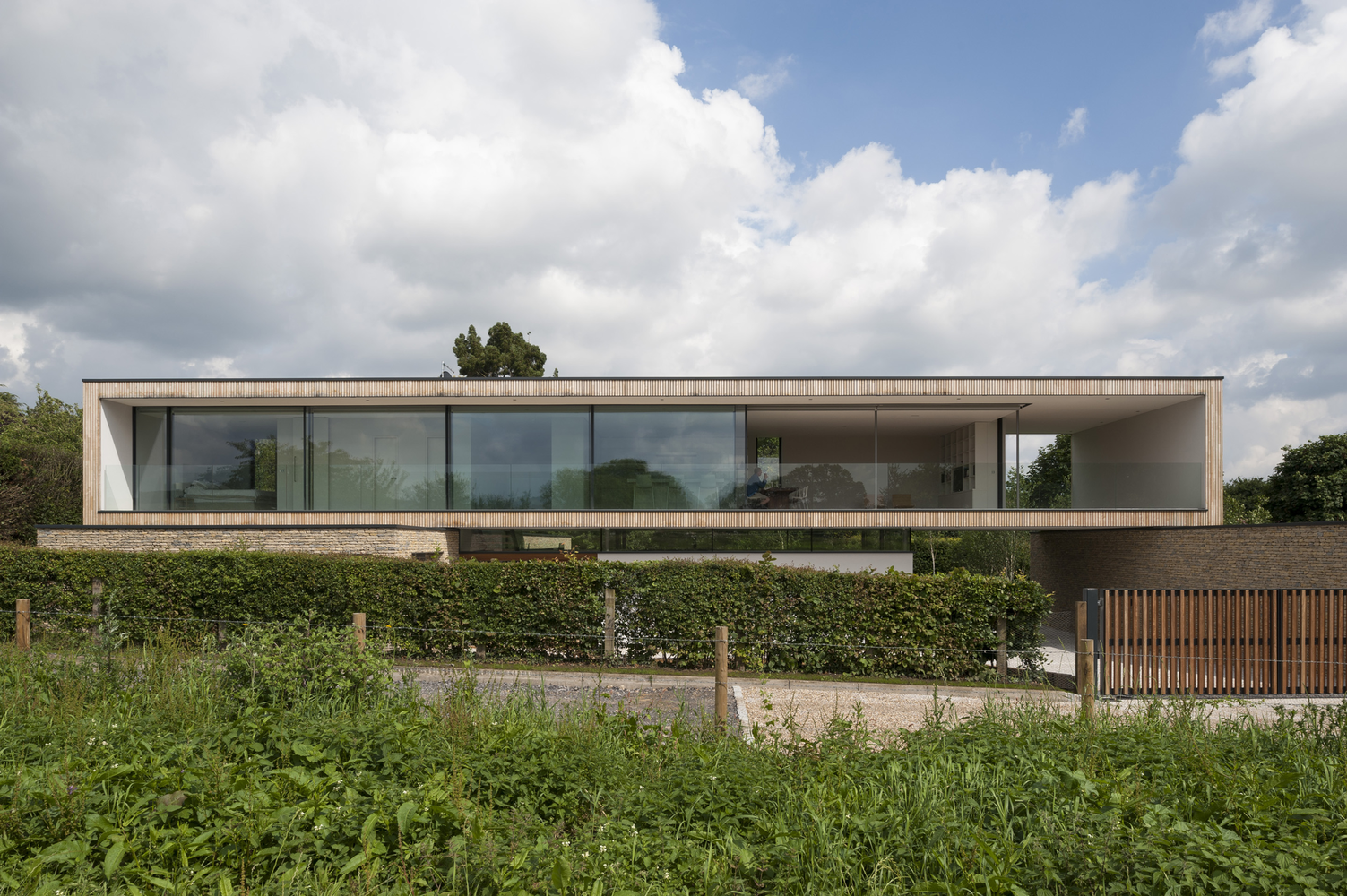 Modern house with large windows and wooden facade HD Wallpaper