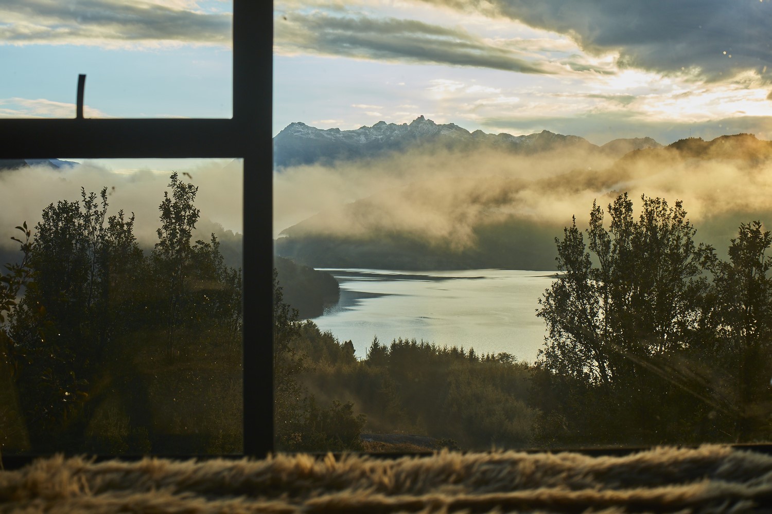 Lake and mountains viewed through a window at sunrise HD Wallpaper