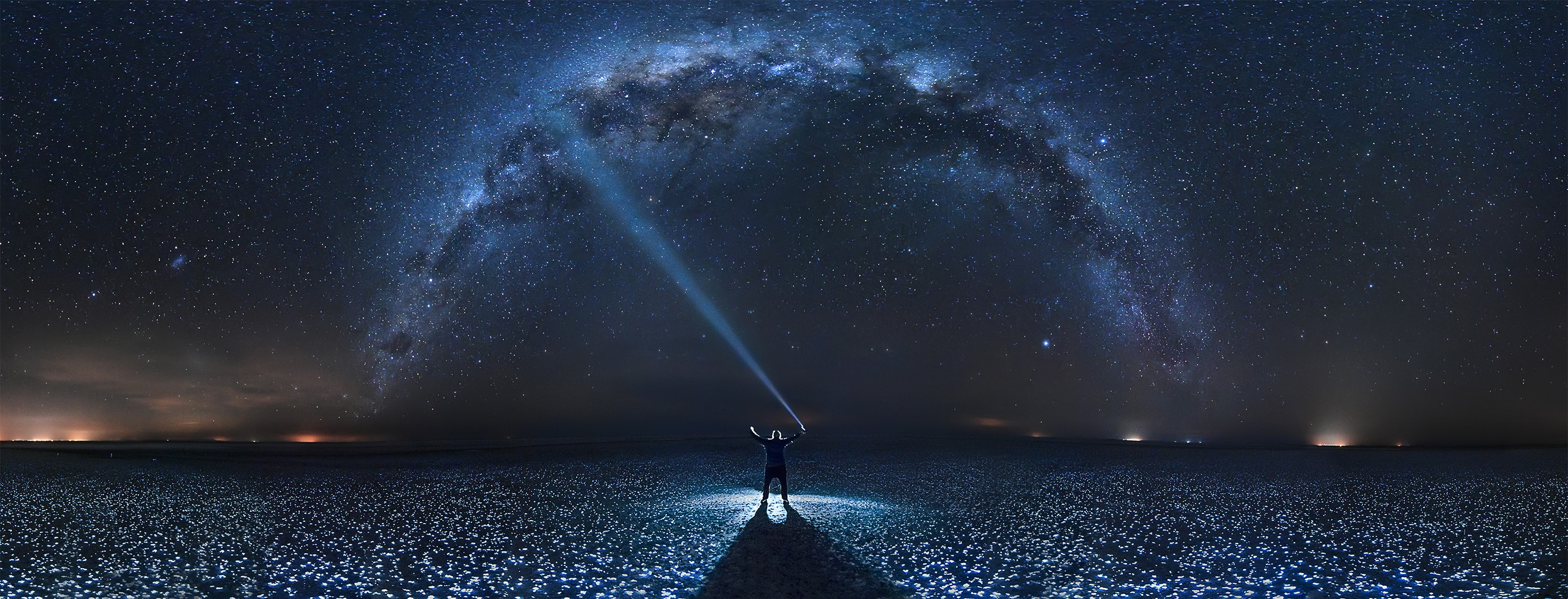 Man with flashlight under the Milky Way HD Wallpaper