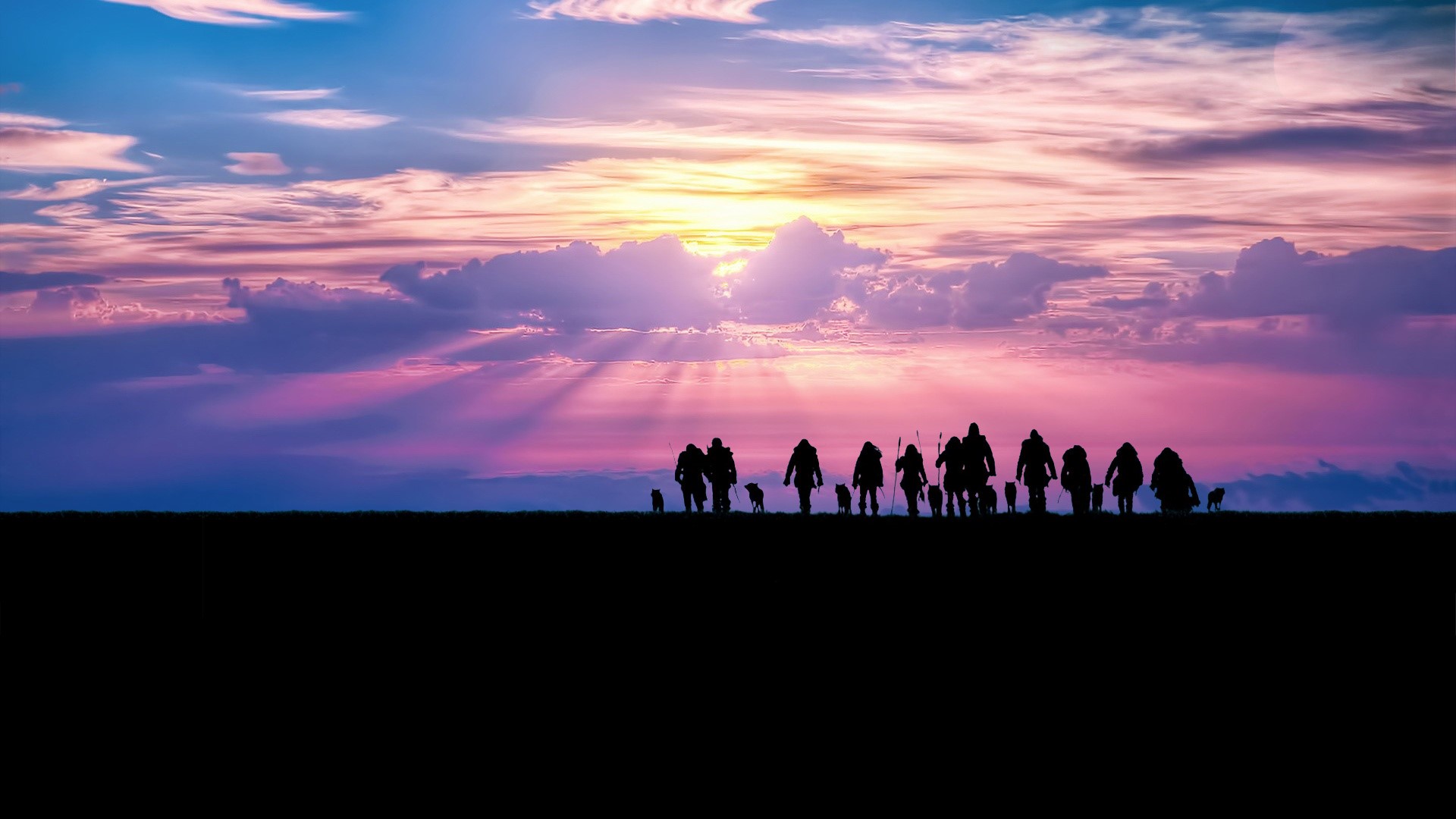 Silhouettes of people and dogs against a sunset sky HD Wallpaper