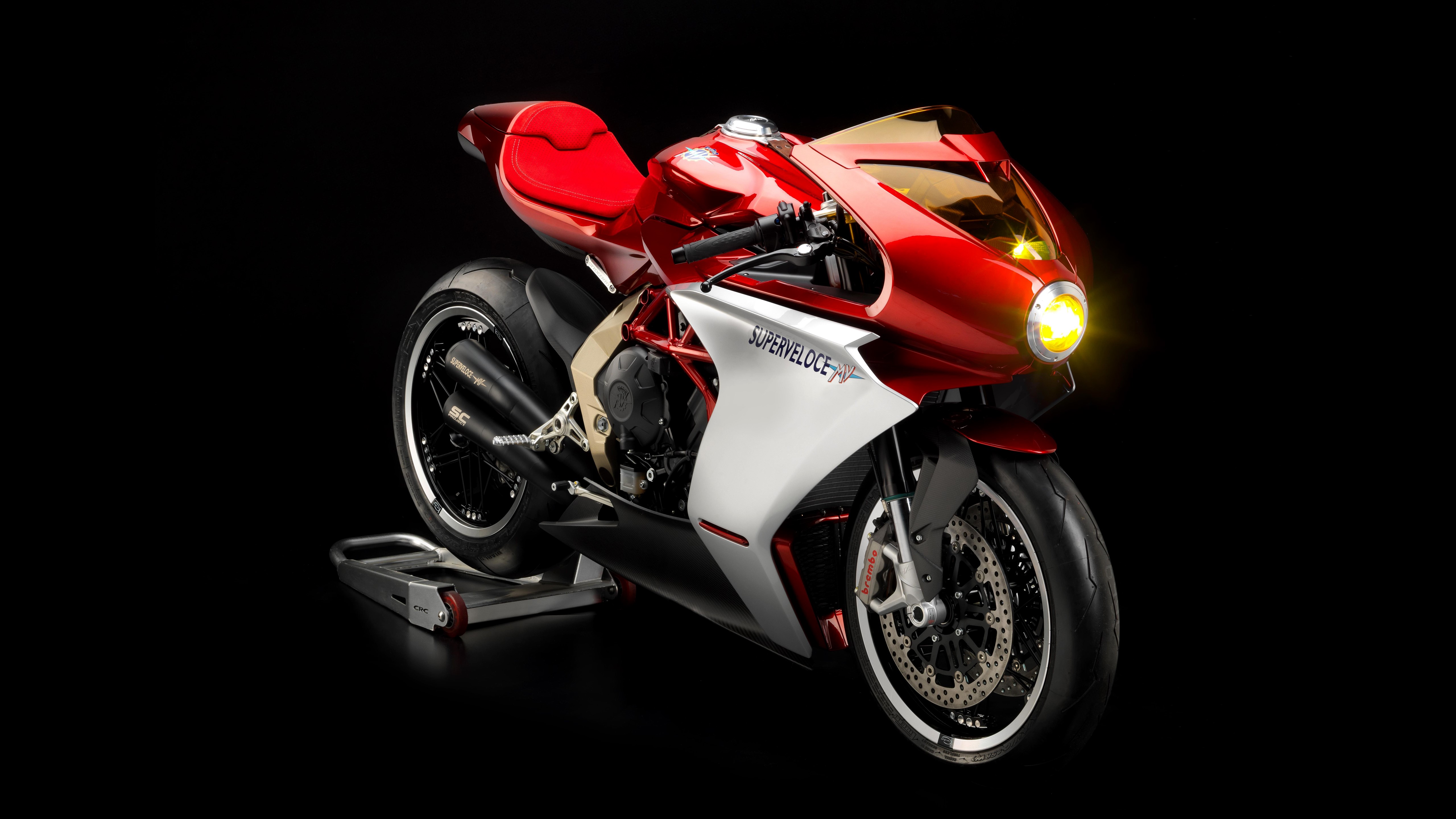 4K motorcycle with red and white body on black background HD Wallpaper