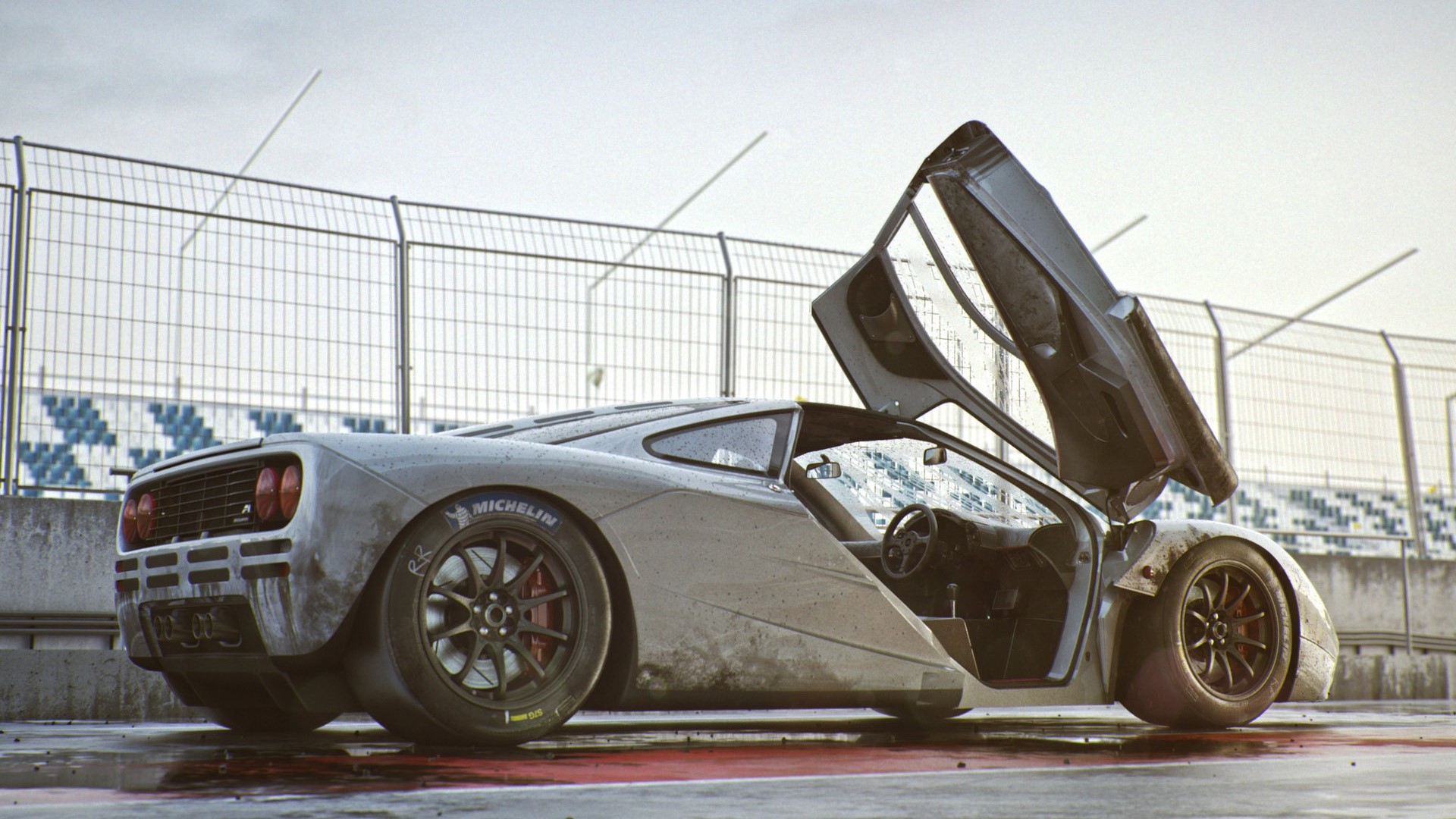 McLaren F1 car on a wet race track HD Wallpaper