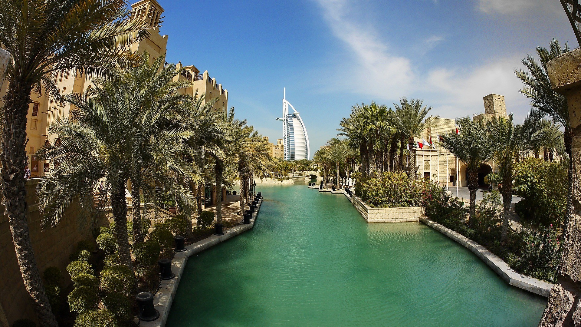 Burj Al Arab hotel and canal in Dubai with palm trees HD Wallpaper