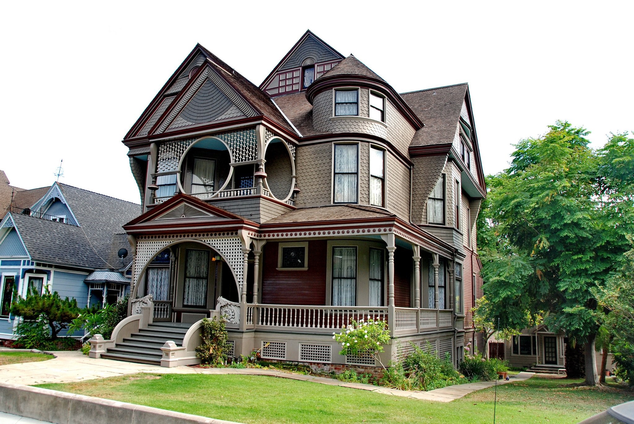 Victorian house with trees and rooftops HD Wallpaper