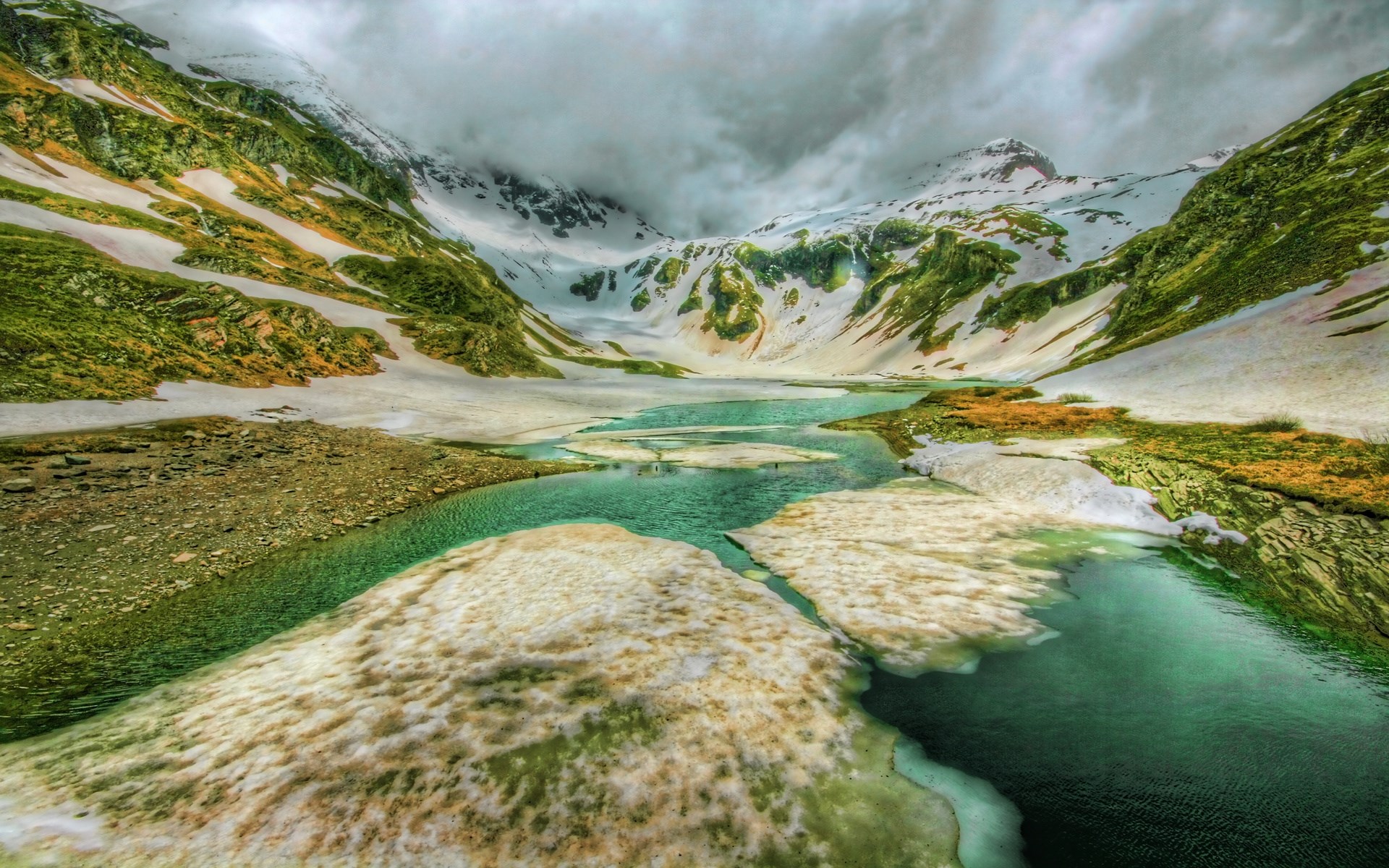 Turquoise lake in a snowy mountain landscape HD Wallpaper