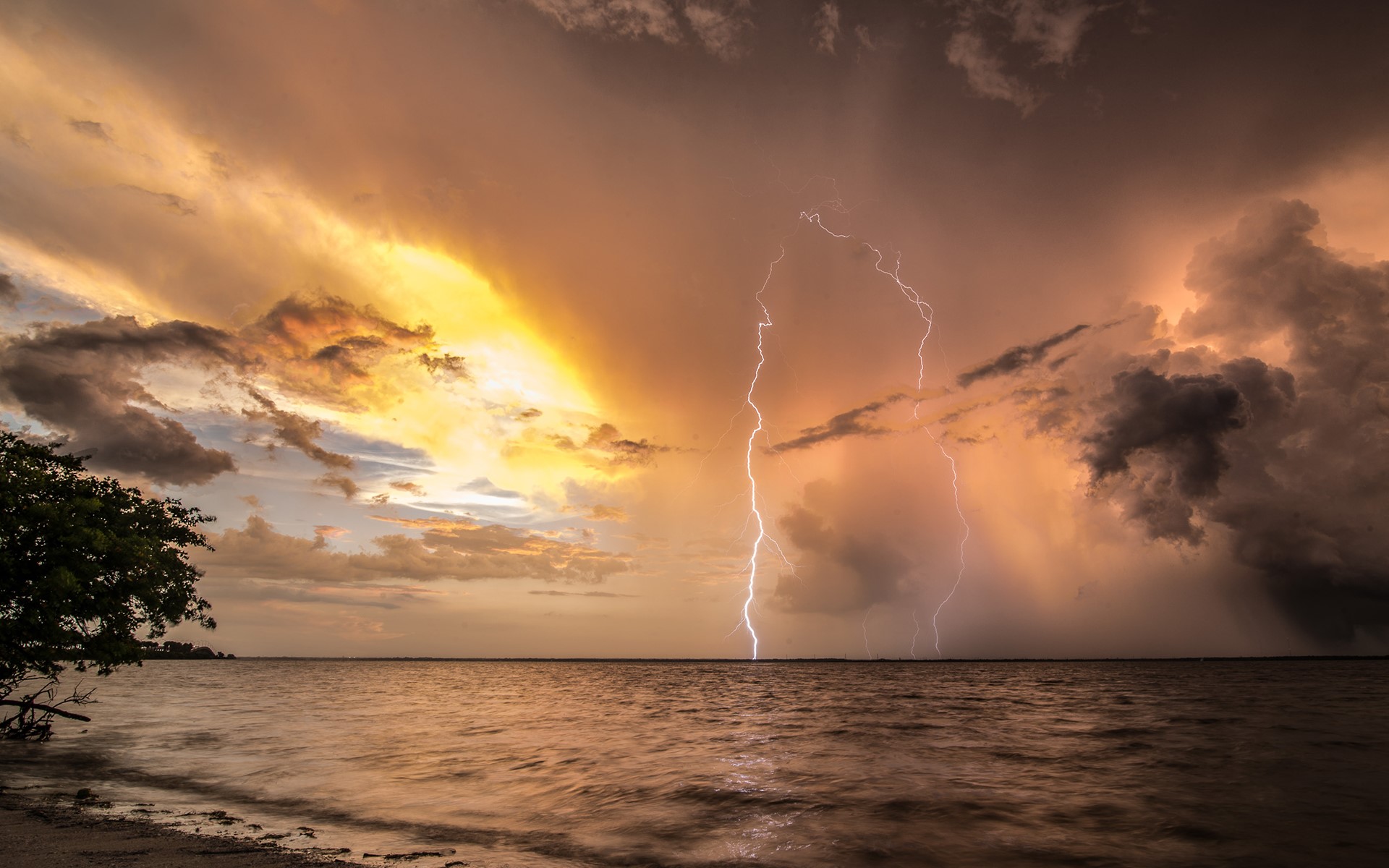 Lightning strikes over the sea during a storm HD Wallpaper