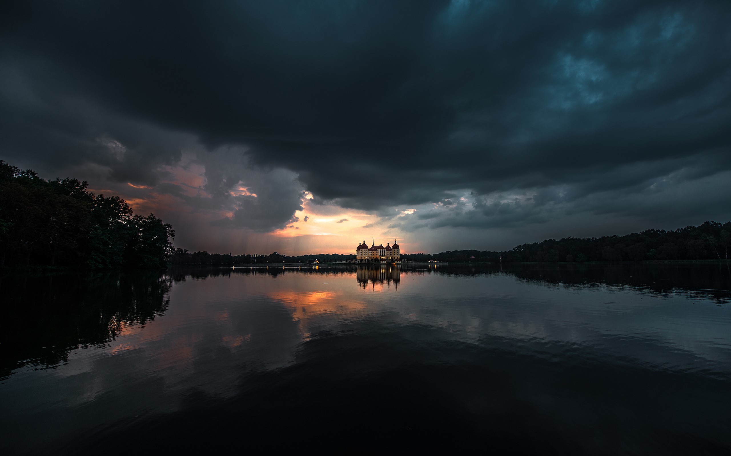 Moritzburg Castle reflected in a lake under dark clouds HD Wallpaper
