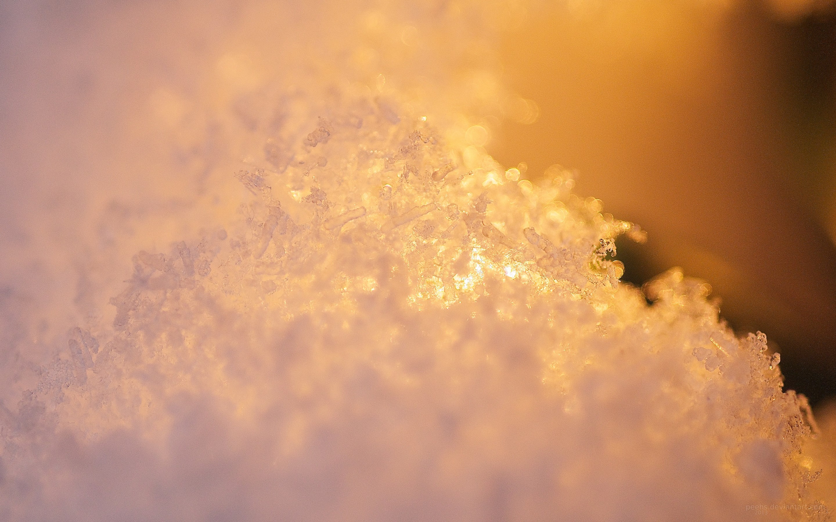 Macro view of snow crystals illuminated by warm light HD Wallpaper