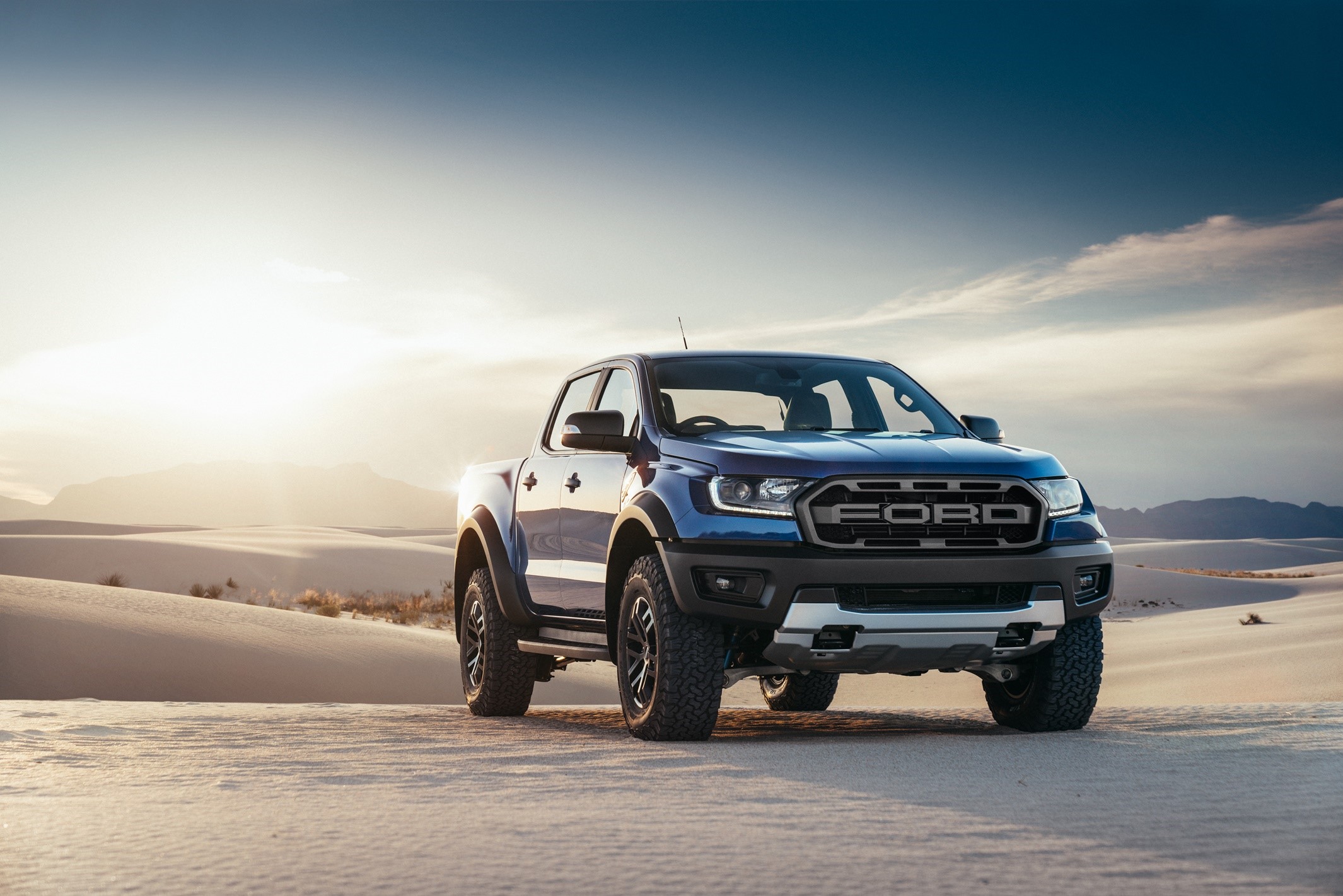 Blue Ford Ranger Raptor pickup truck in desert landscape HD Wallpaper