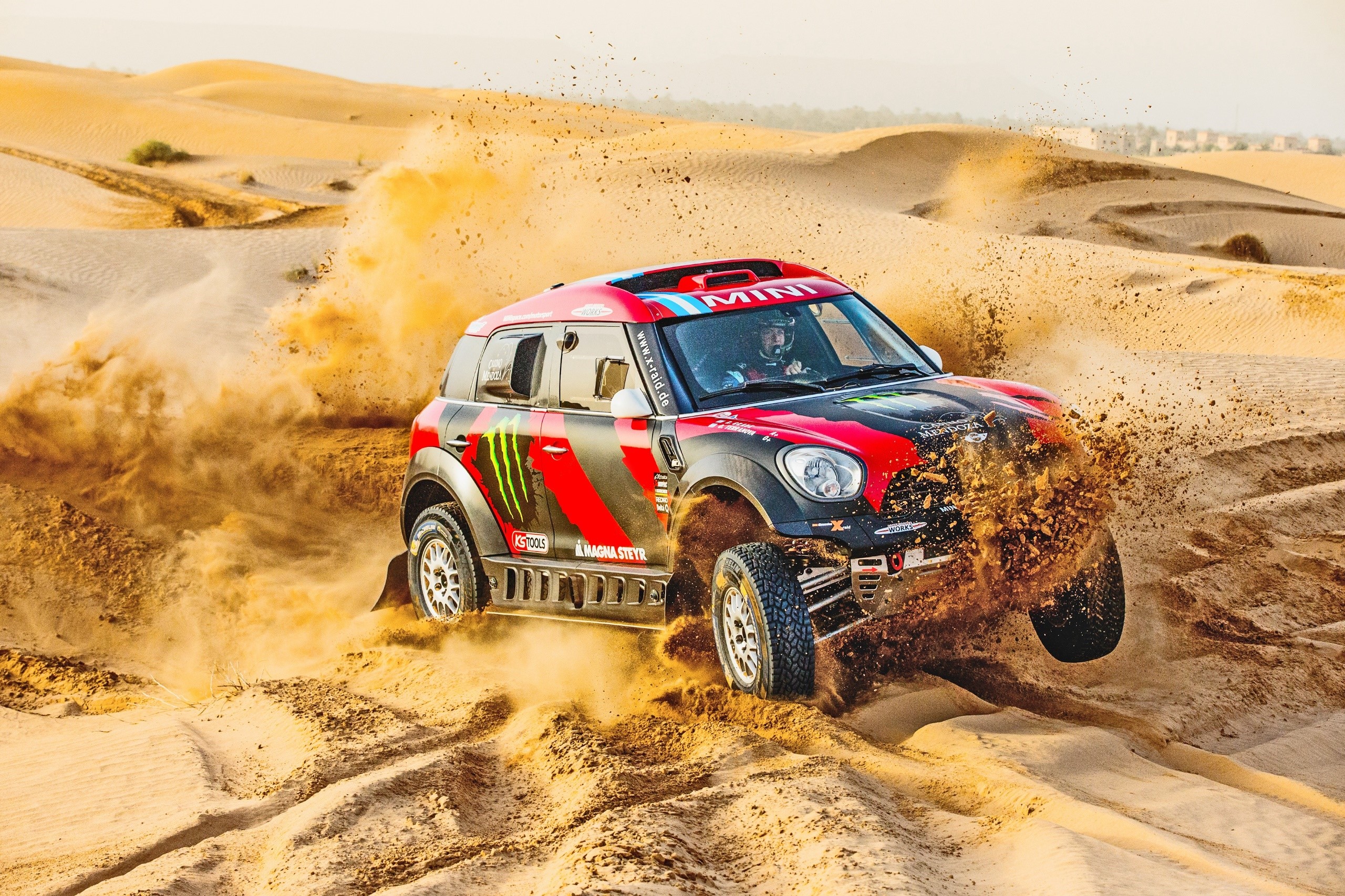 Mini Cooper rally car racing through desert sand dunes HD Wallpaper