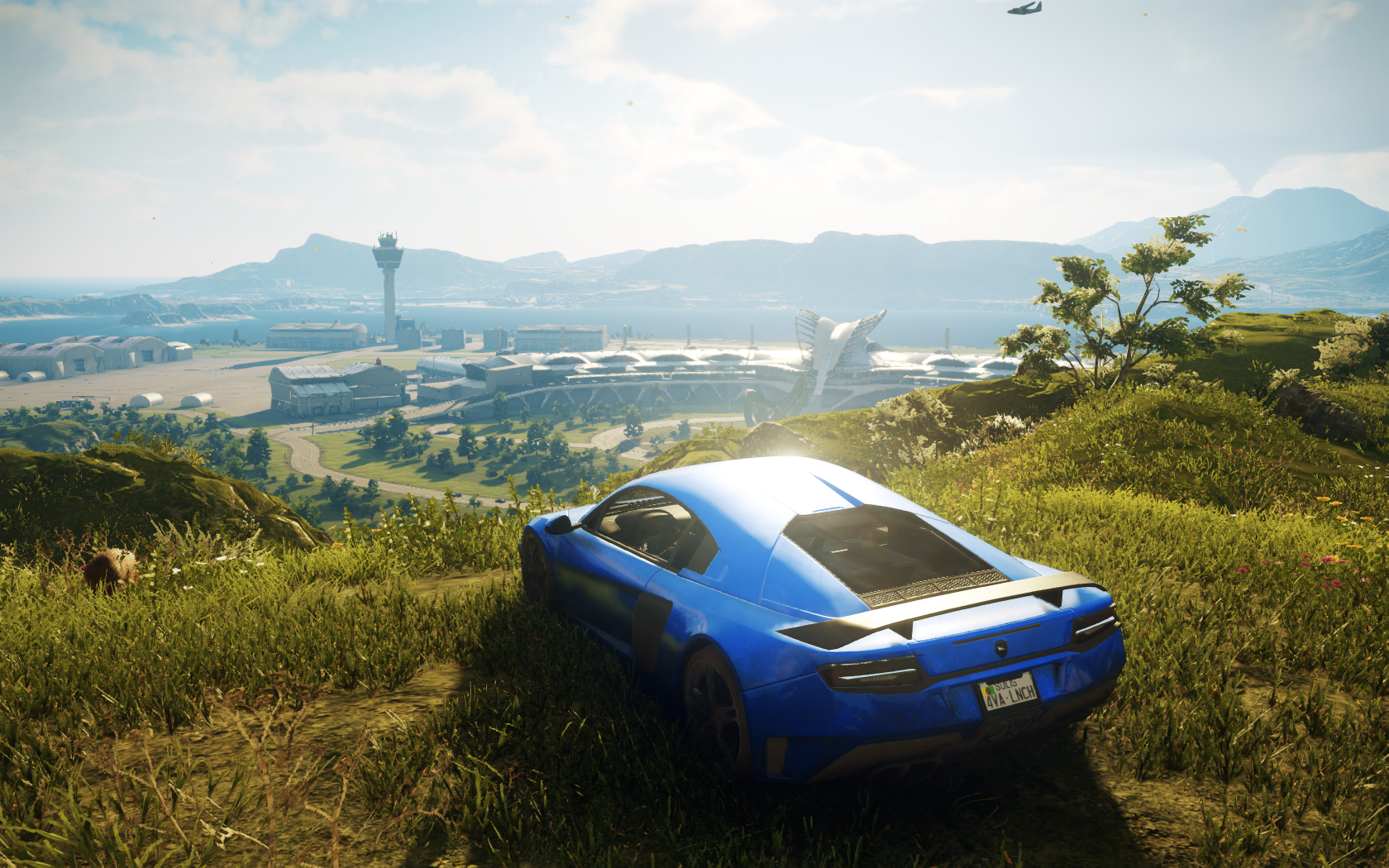 Blue sports car overlooking an airport in Just Cause 4 HD Wallpaper