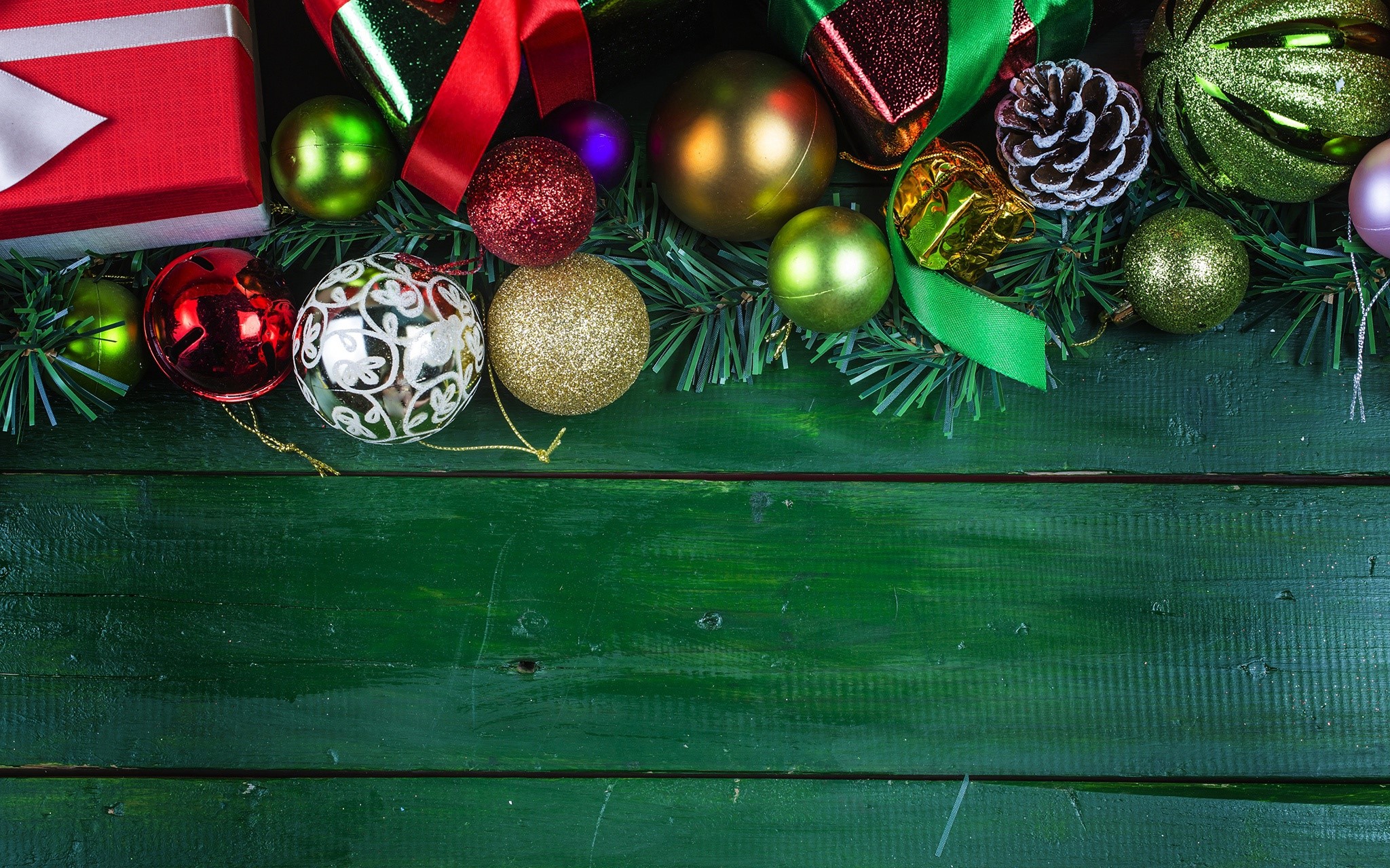 Christmas ornaments and gift on a green wooden surface HD Wallpaper