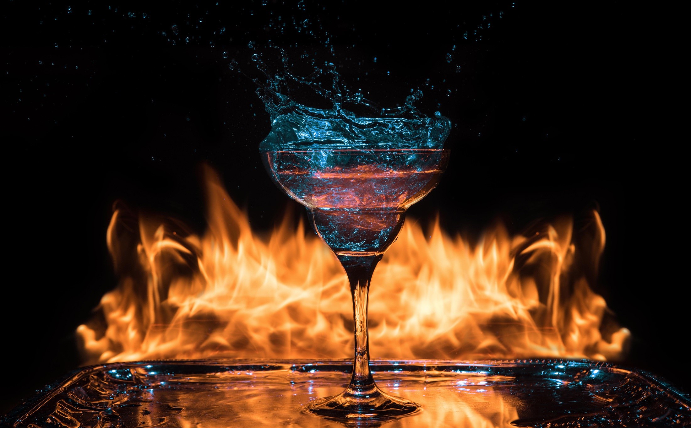 Cocktail glass with water splash and fire HD Wallpaper