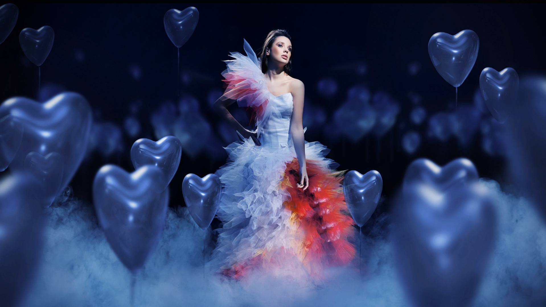 Woman in a dramatic dress surrounded by heart balloons HD Wallpaper