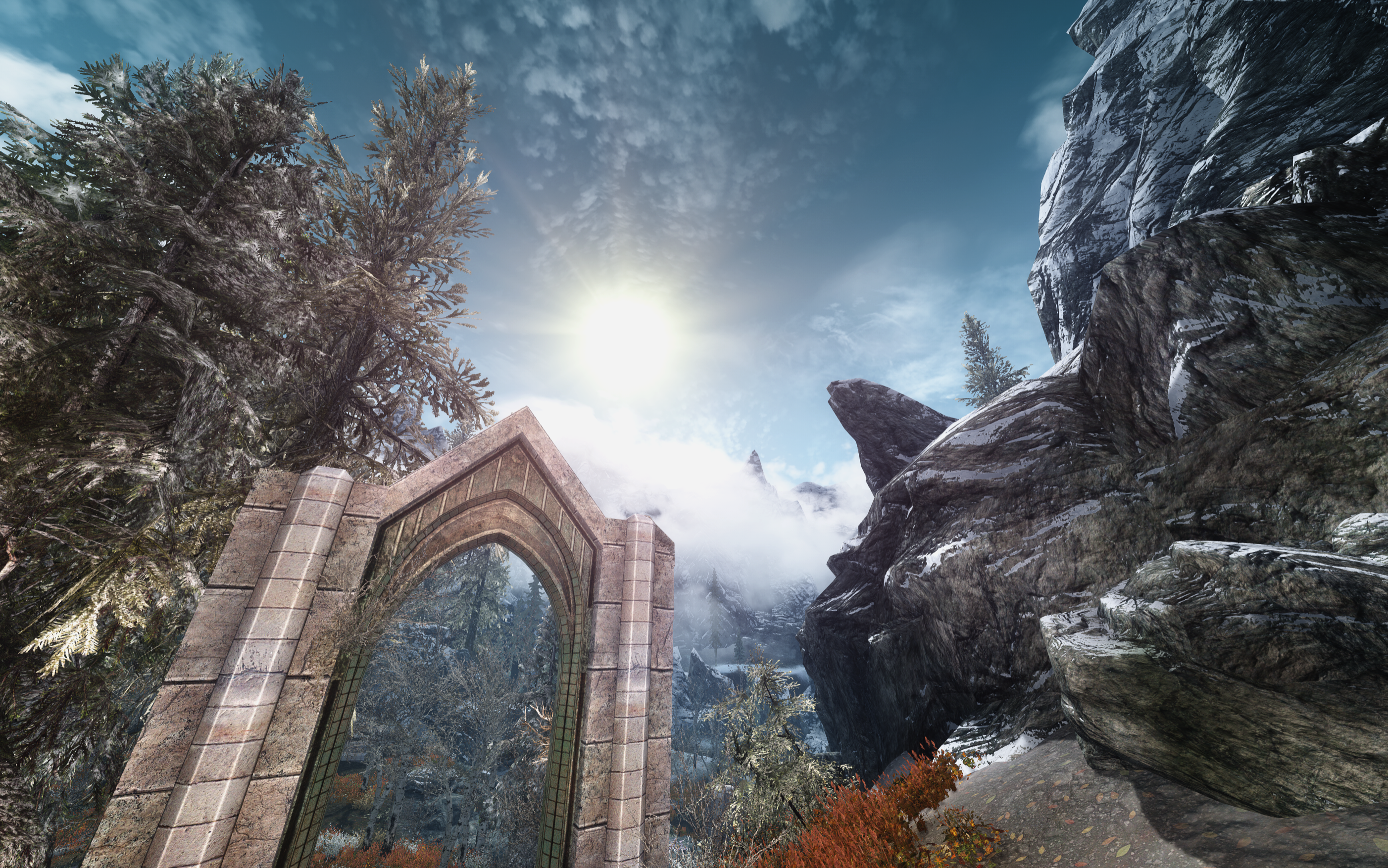 The Elder Scrolls V: Skyrim screenshot with stone archway and mountains HD Wallpaper
