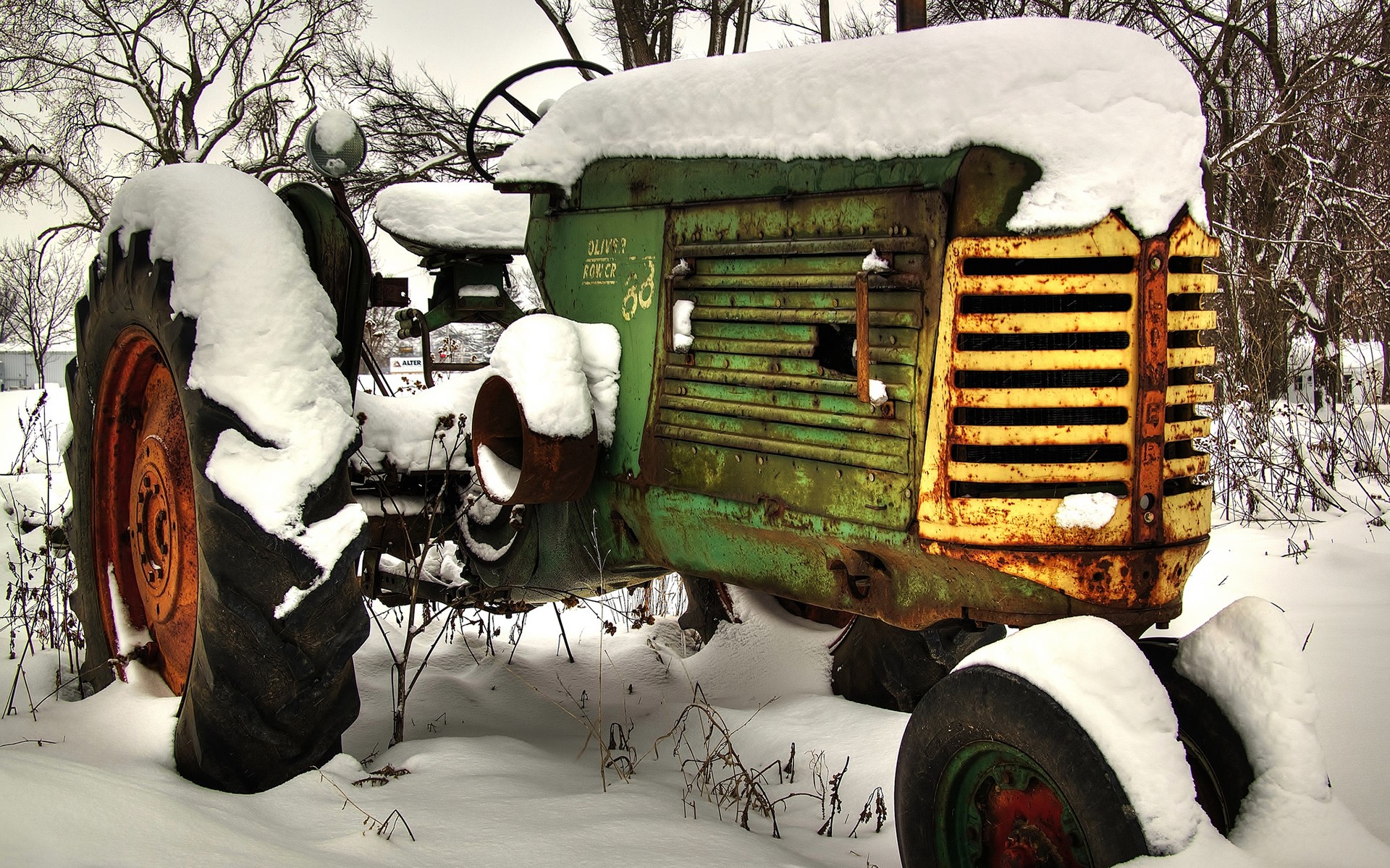 Old green tractor covered in snow HD Wallpaper