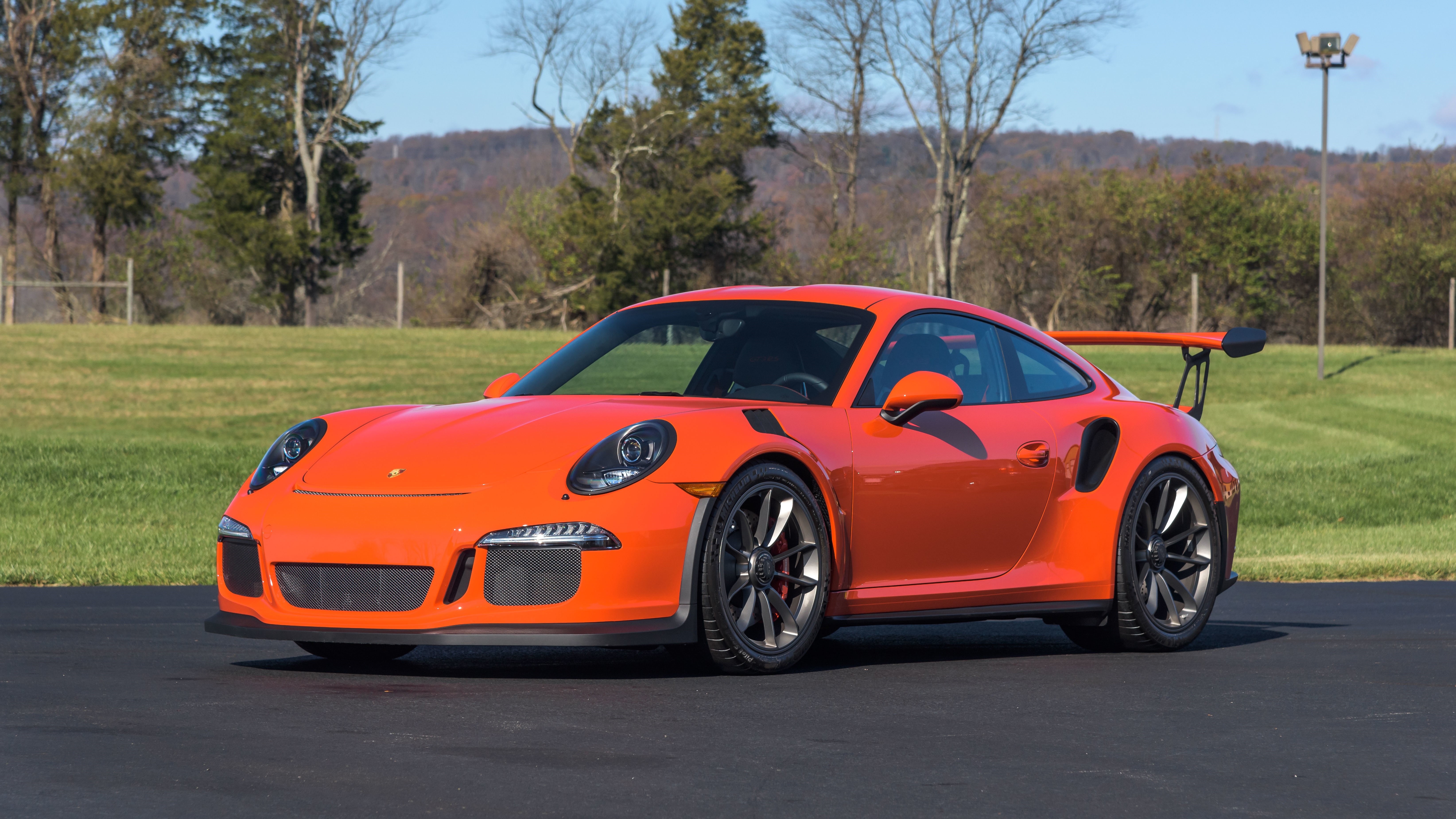 Orange Porsche 911 GT3 RS on asphalt HD Wallpaper