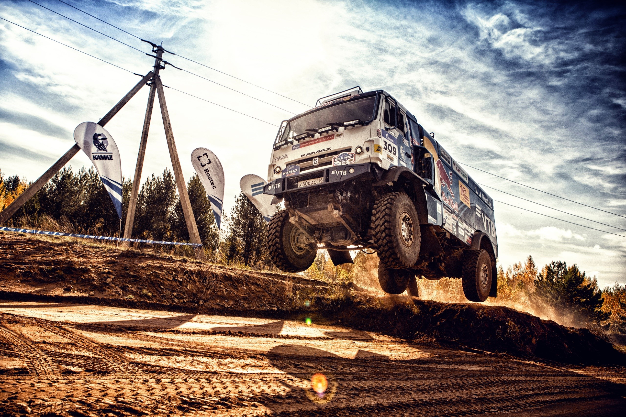 Kamaz truck jumping over dirt ramp HD Wallpaper
