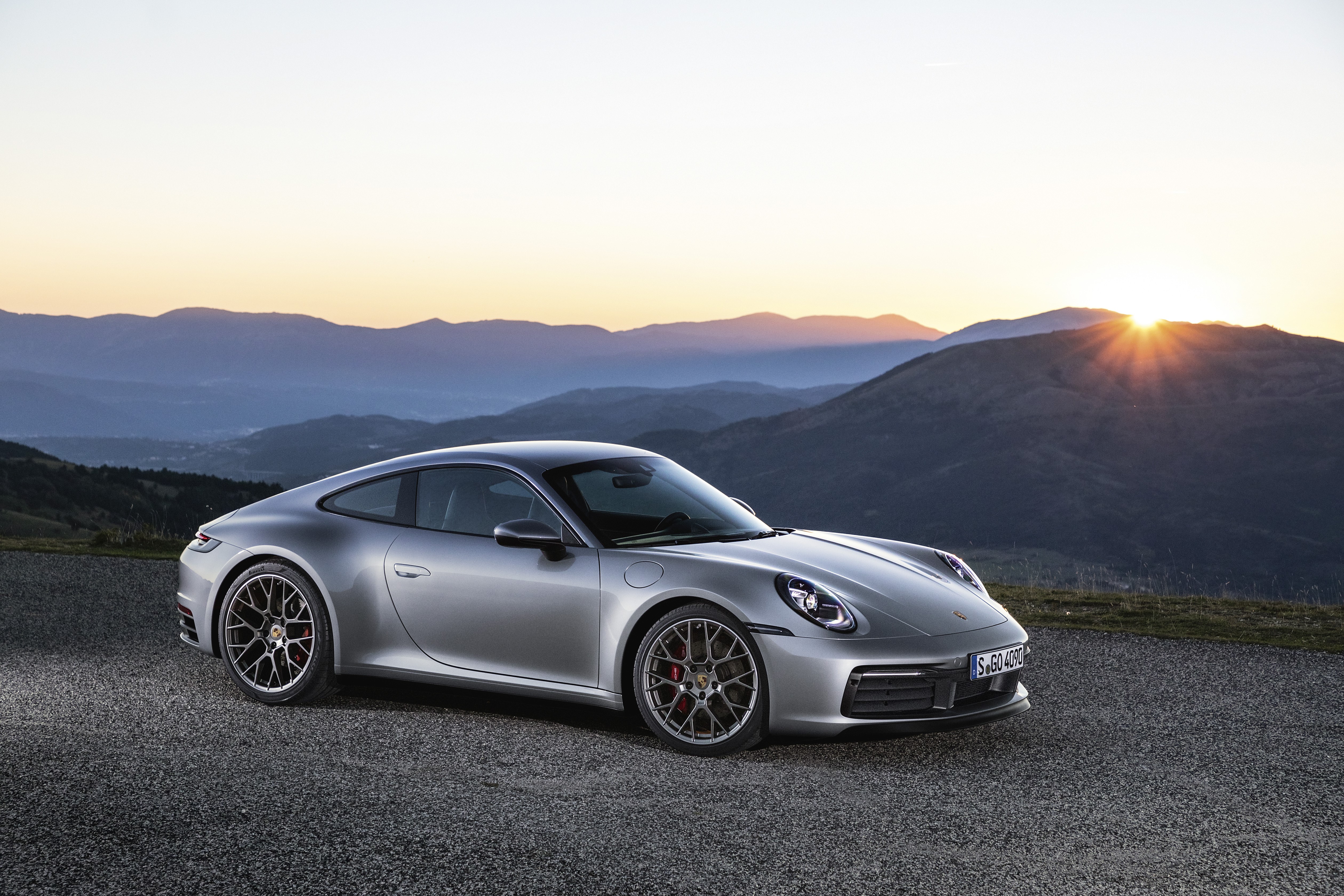 Porsche 911 sports car on a mountain road at sunset HD Wallpaper