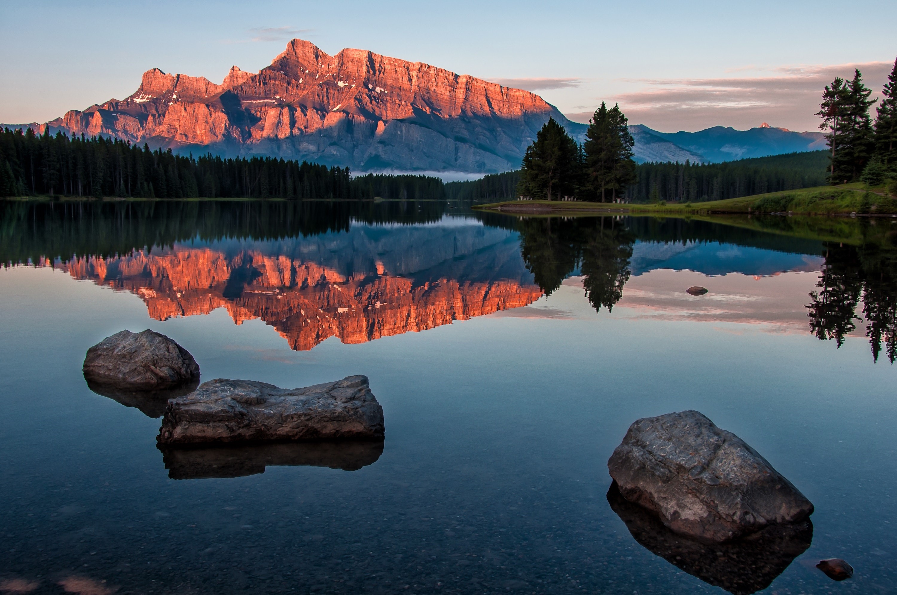 Mountaintop reflection on a calm lake at sunrise HD Wallpaper