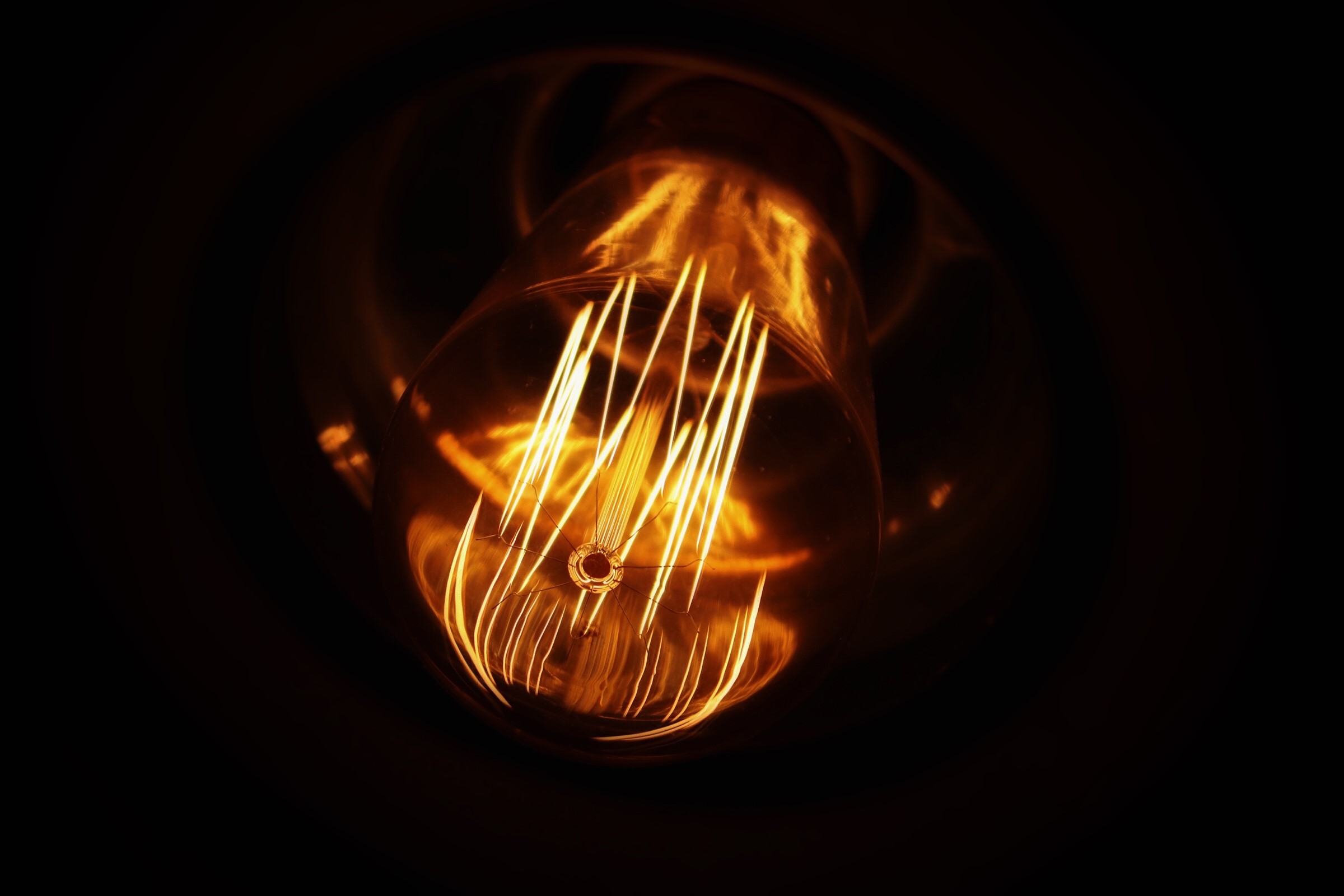 Close-up of a glowing Edison light bulb HD Wallpaper