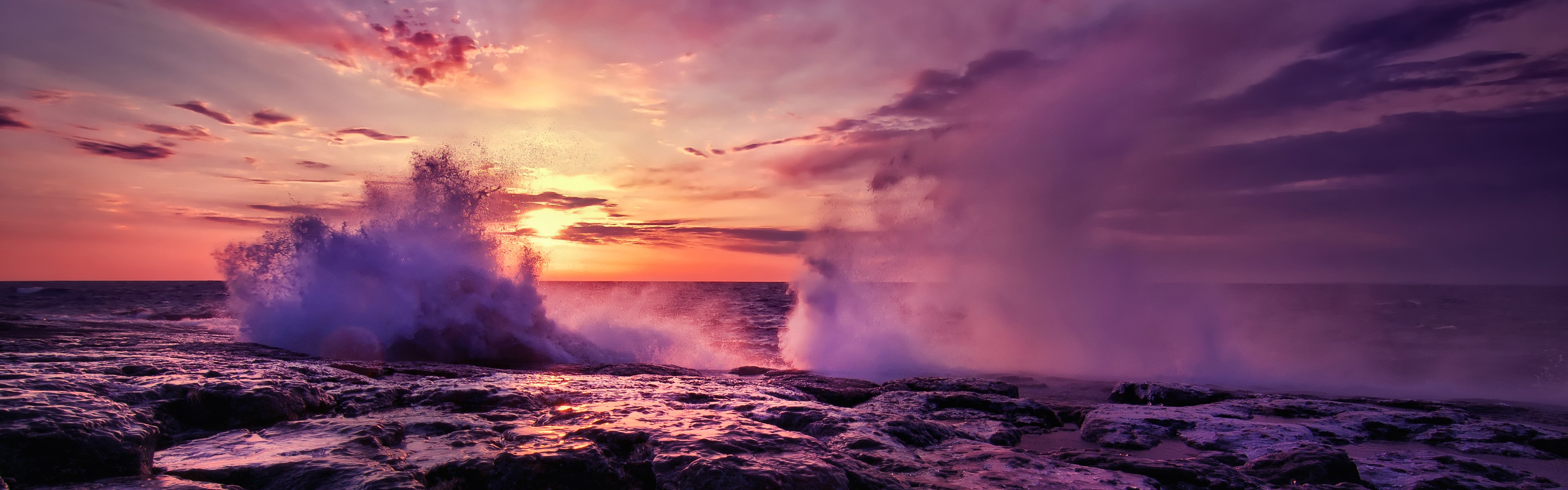 4K waves crashing on rocky coast at sunset HD Wallpaper