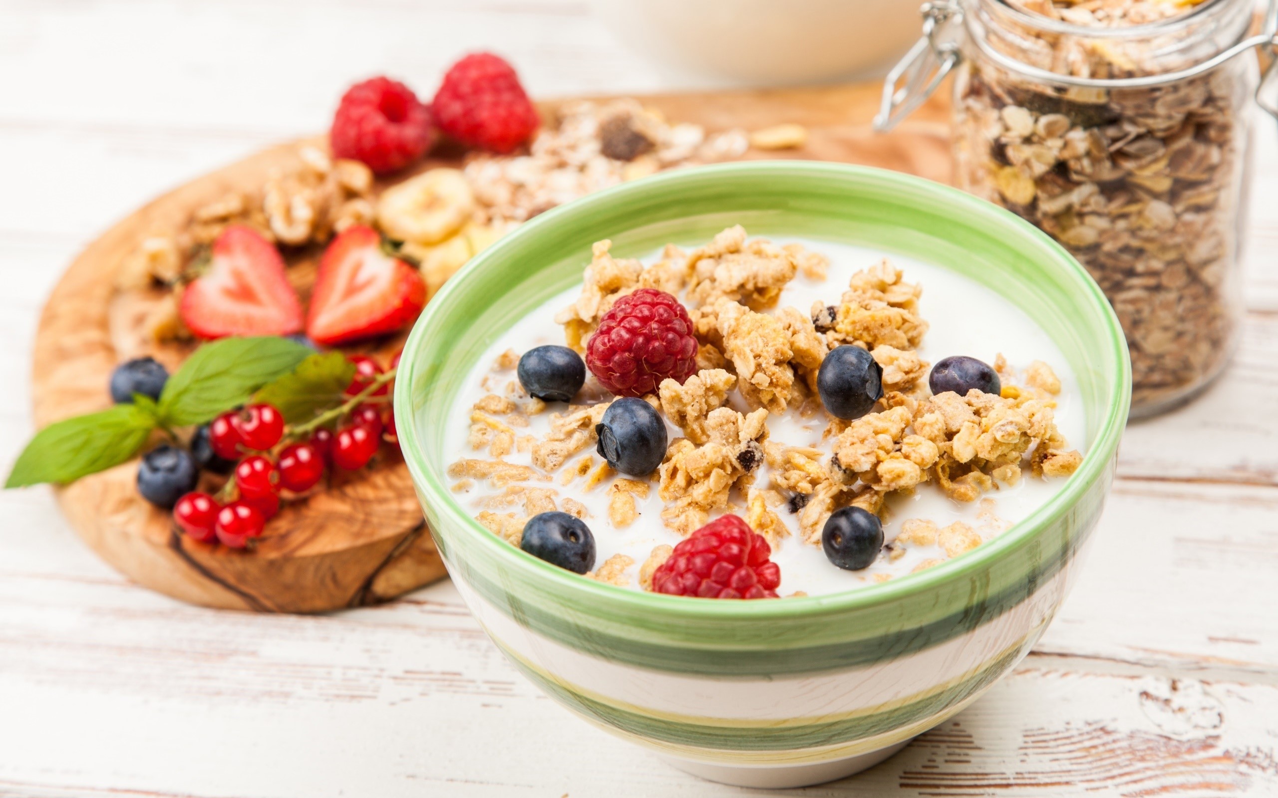 Bowl of granola with berries and a jar of granola HD Wallpaper
