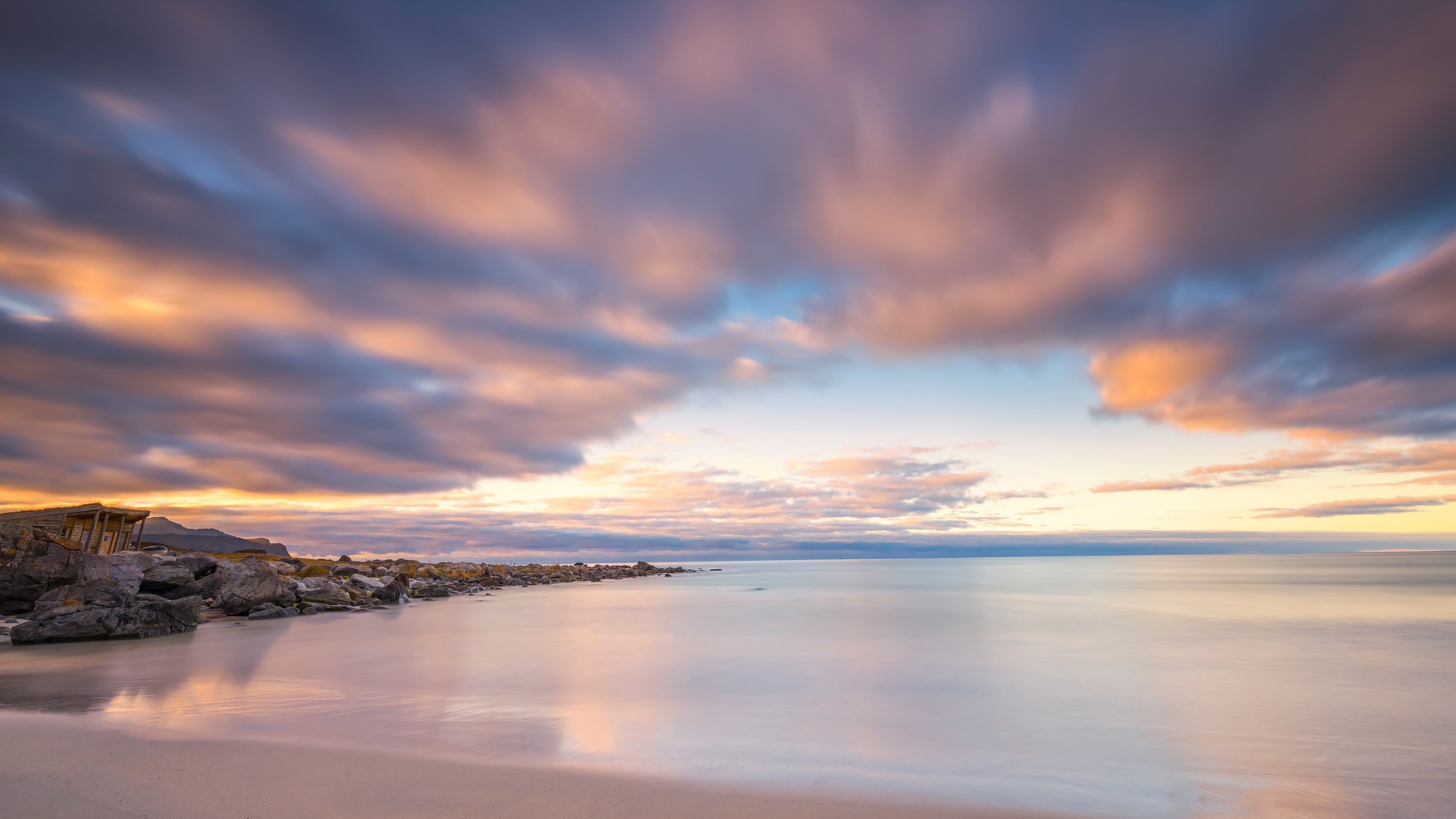 4K beach sunset with calm water and clouds HD Wallpaper
