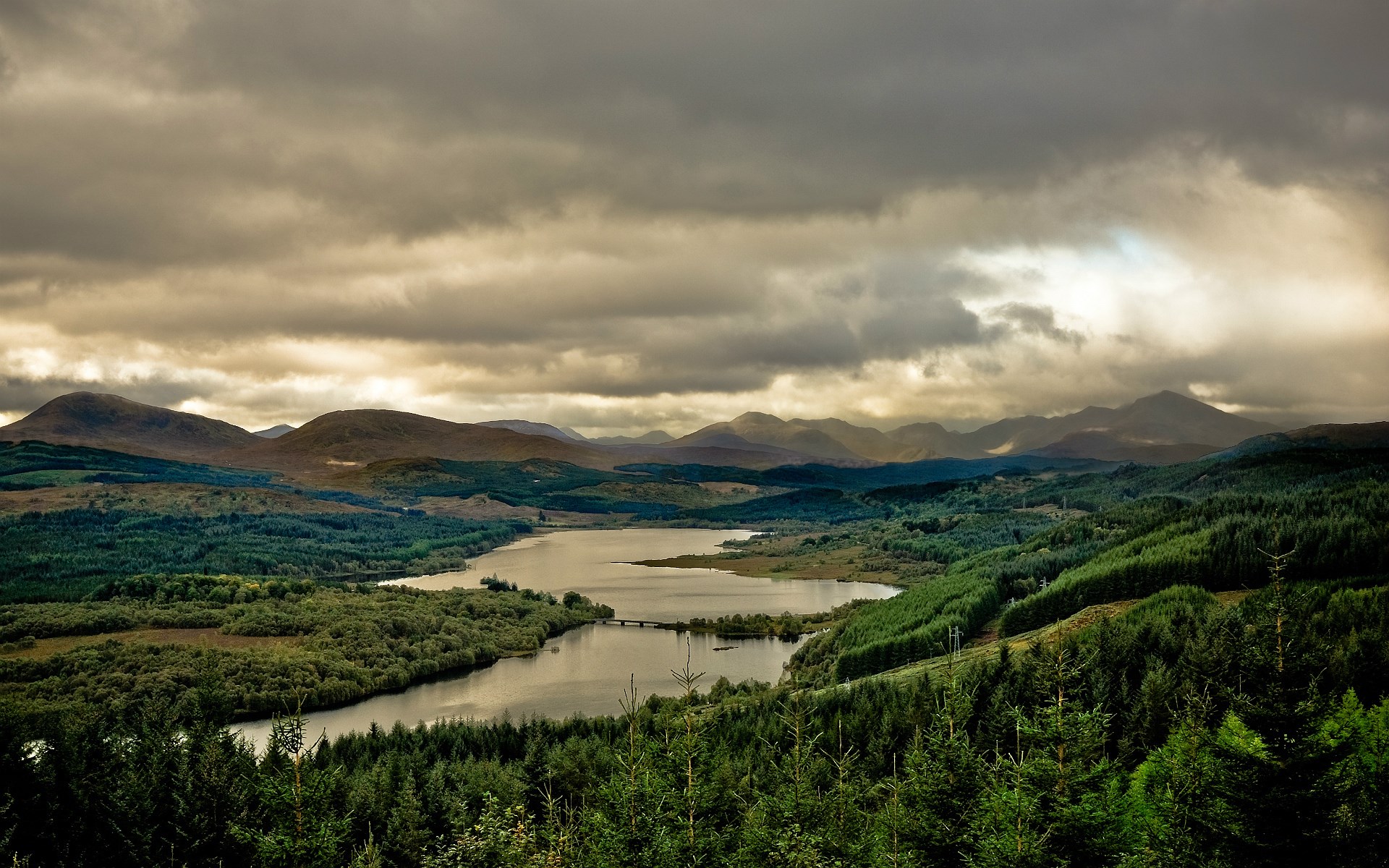 Overcast sky over a lake and forested mountains HD Wallpaper