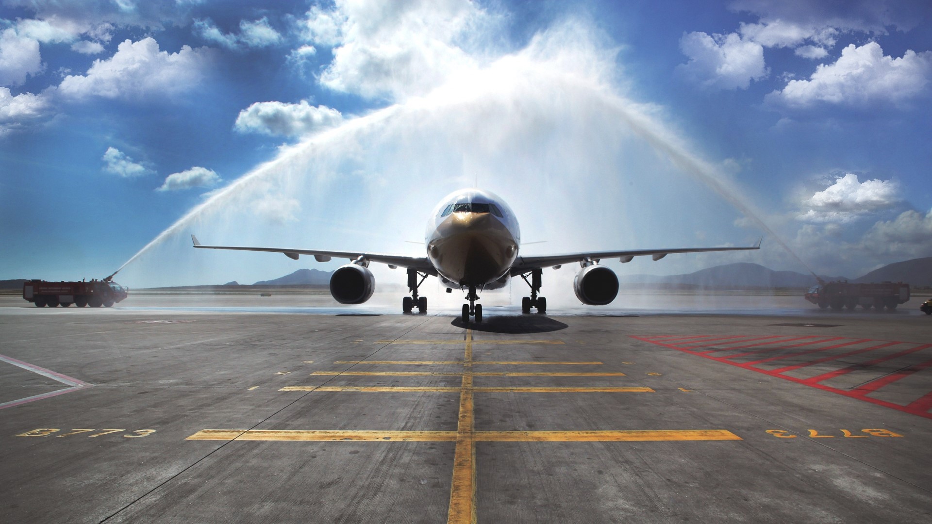 Airplane receiving a water salute on the tarmac HD Wallpaper