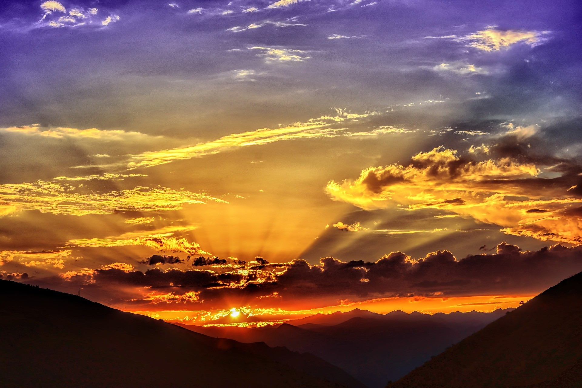 Dramatic sunset over mountains with sun rays HD Wallpaper