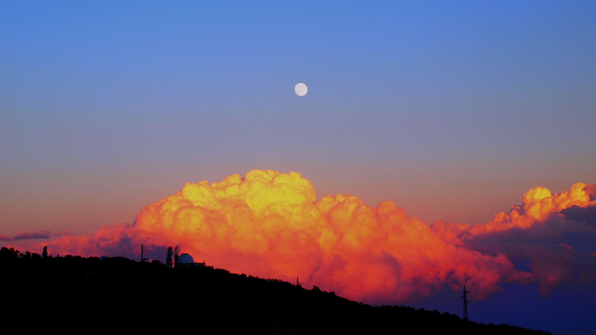 Moon over sunset clouds above silhouette of mountains HD Wallpaper