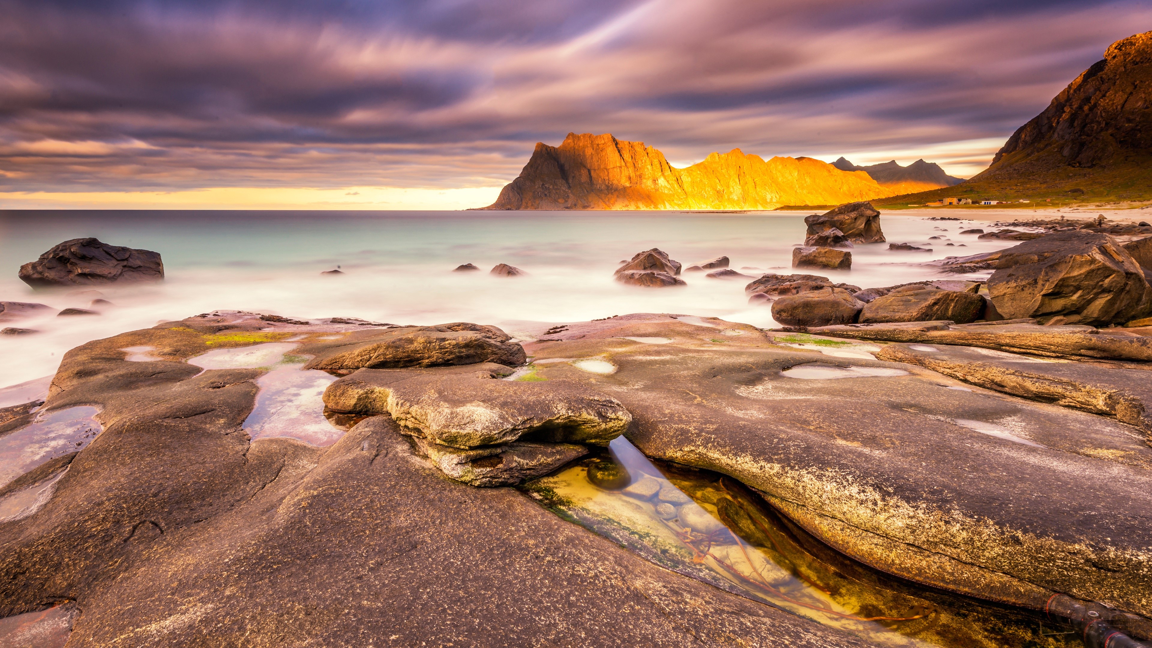 4K rocky coast with mountains at sunset HD Wallpaper