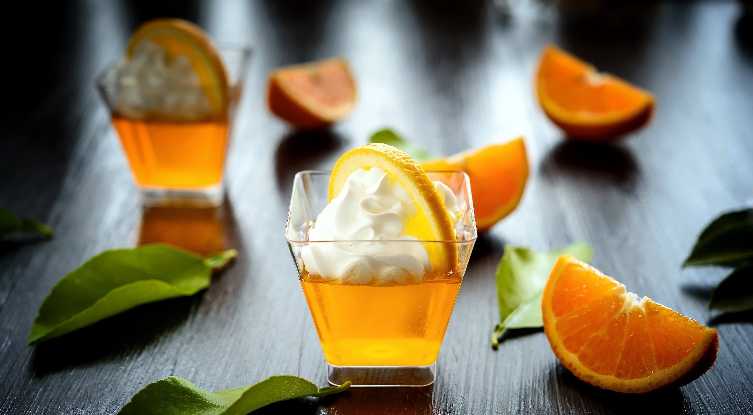 Orange jelly desserts with whipped cream and orange slices HD Wallpaper