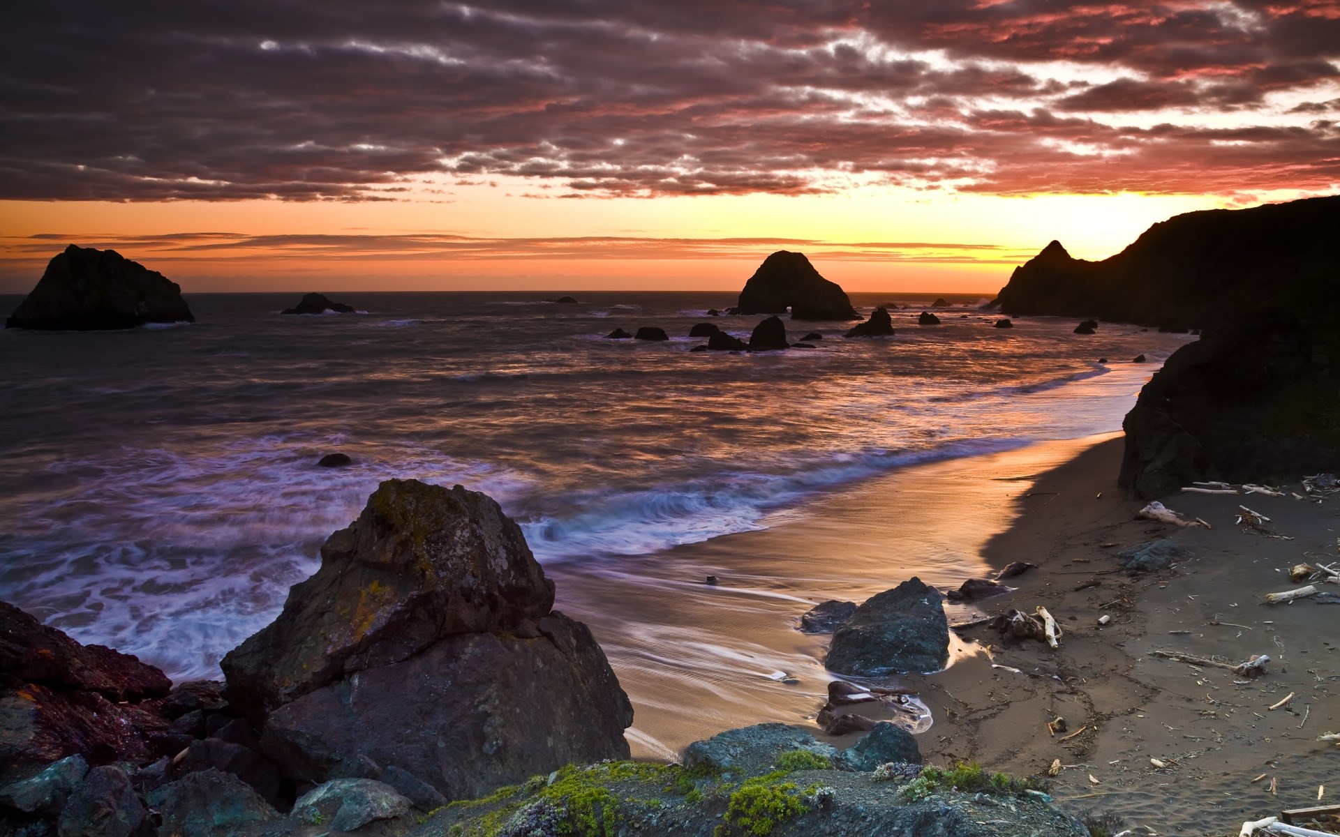 Sunset over rocky coastline with ocean waves HD Wallpaper