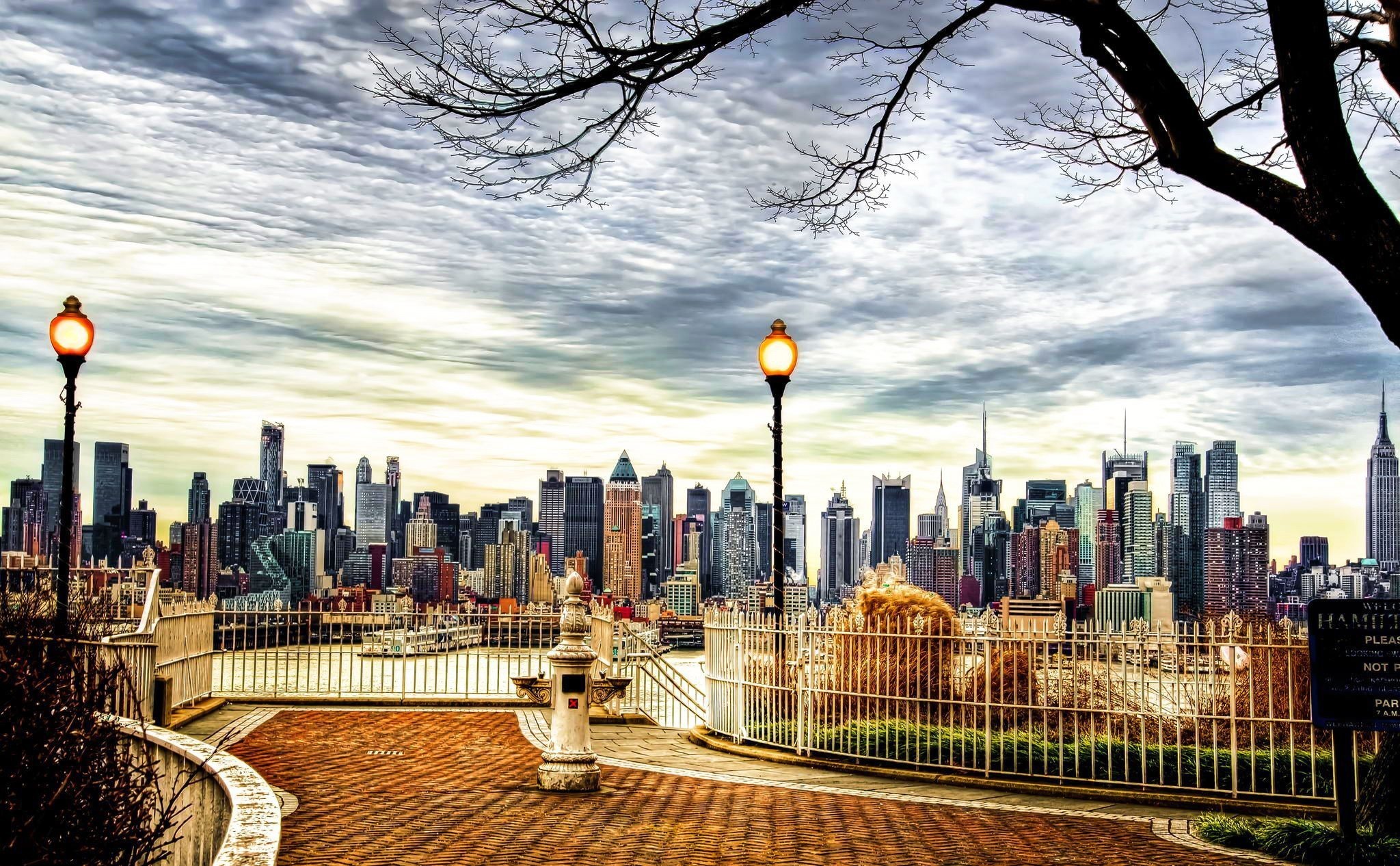New York City skyline from a park with streetlights HD Wallpaper