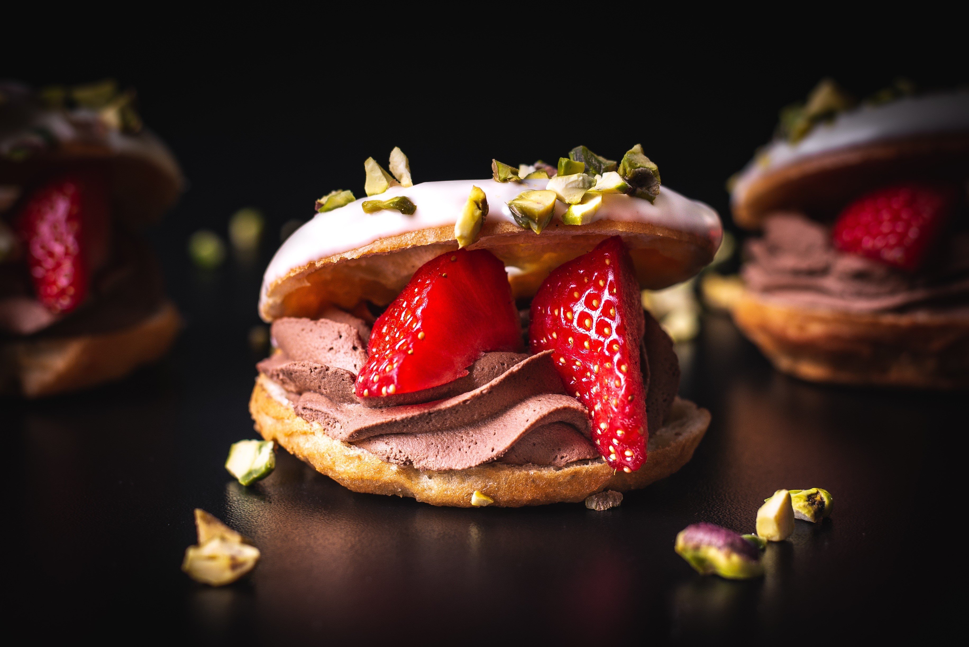 Chocolate cream puffs with strawberries and pistachios HD Wallpaper