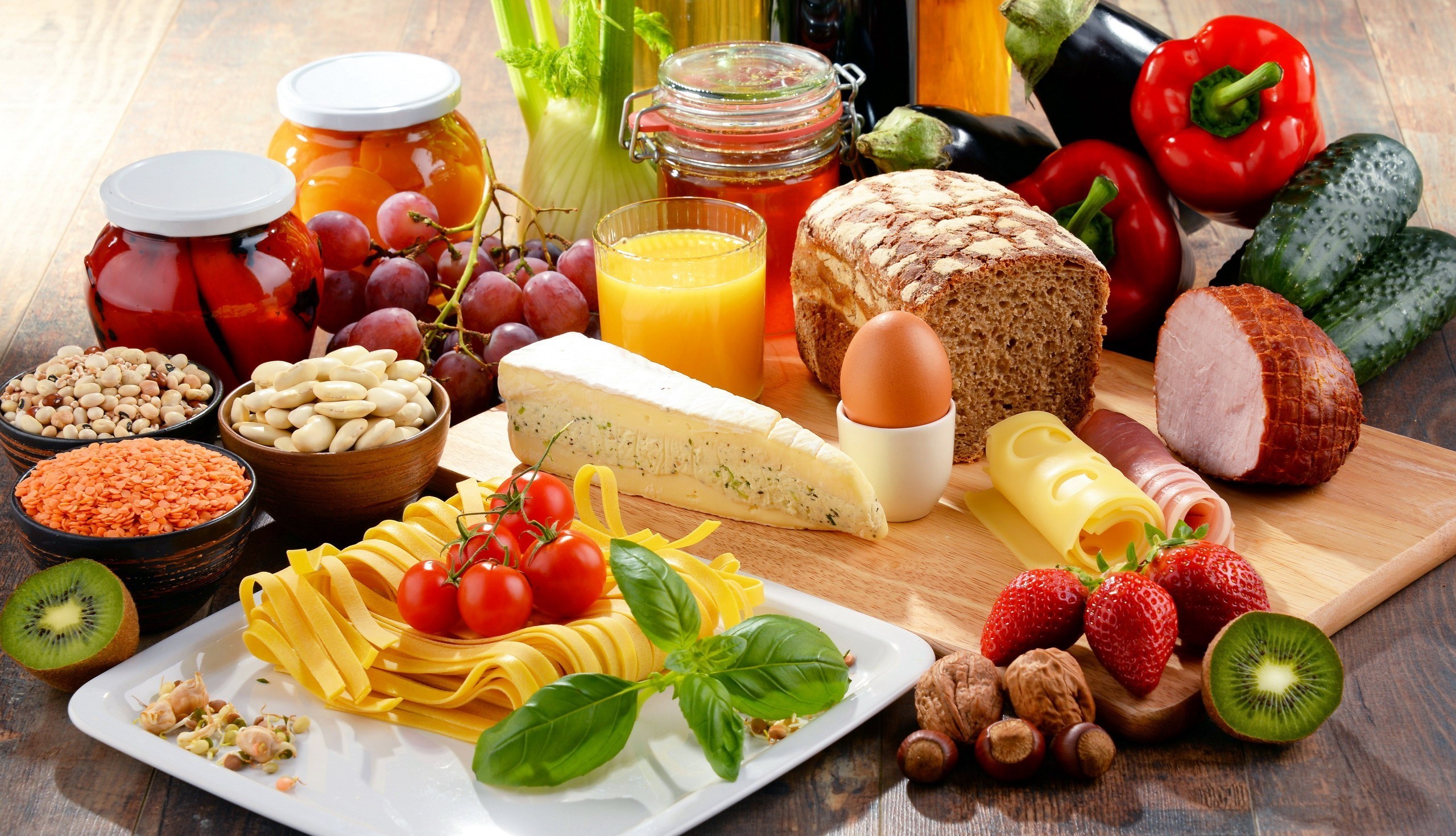 Still life of various foods including fruits, vegetables, bread, and cheese HD Wallpaper