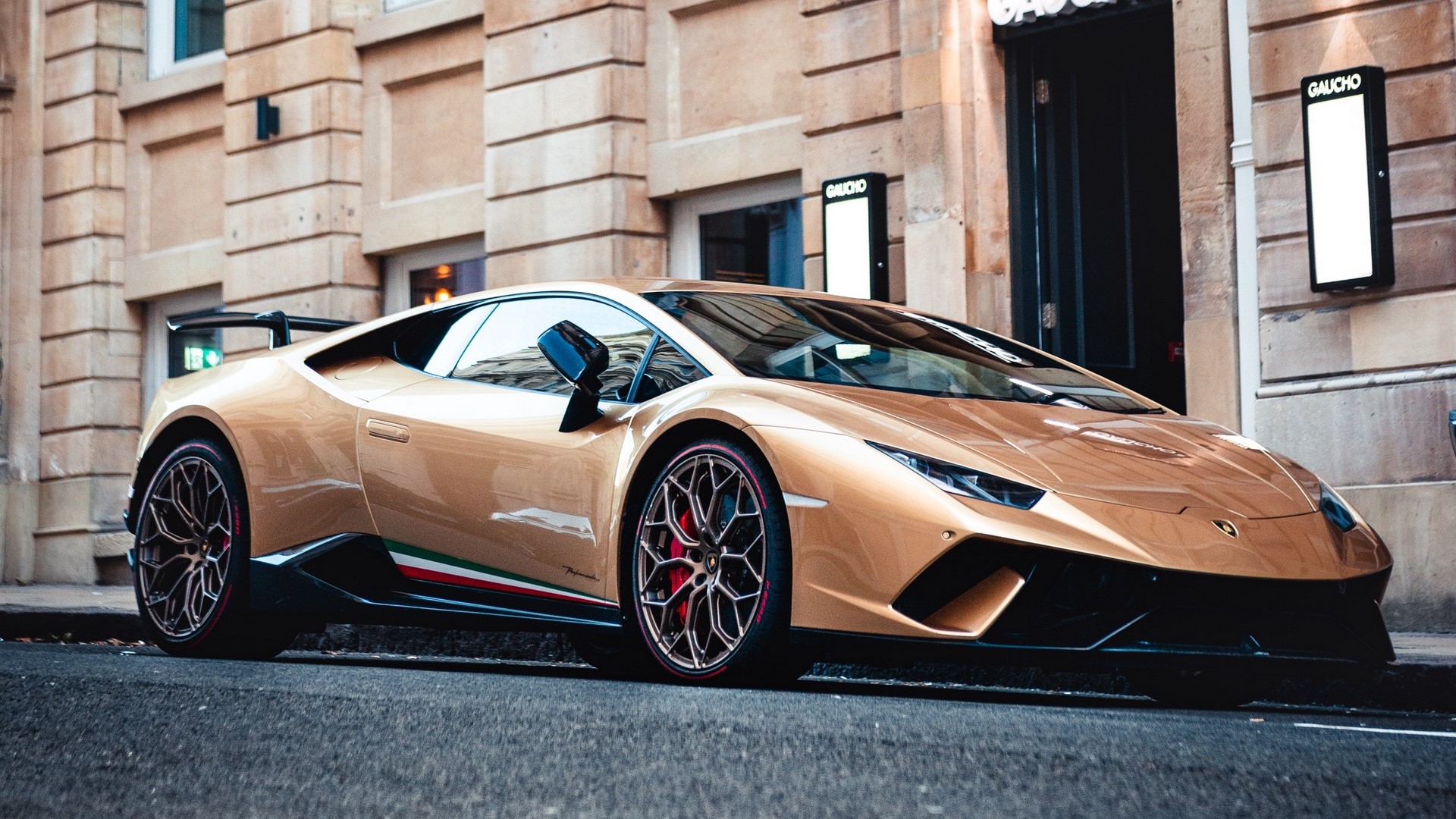 Gold Lamborghini Huracan Performante parked on city street HD Wallpaper