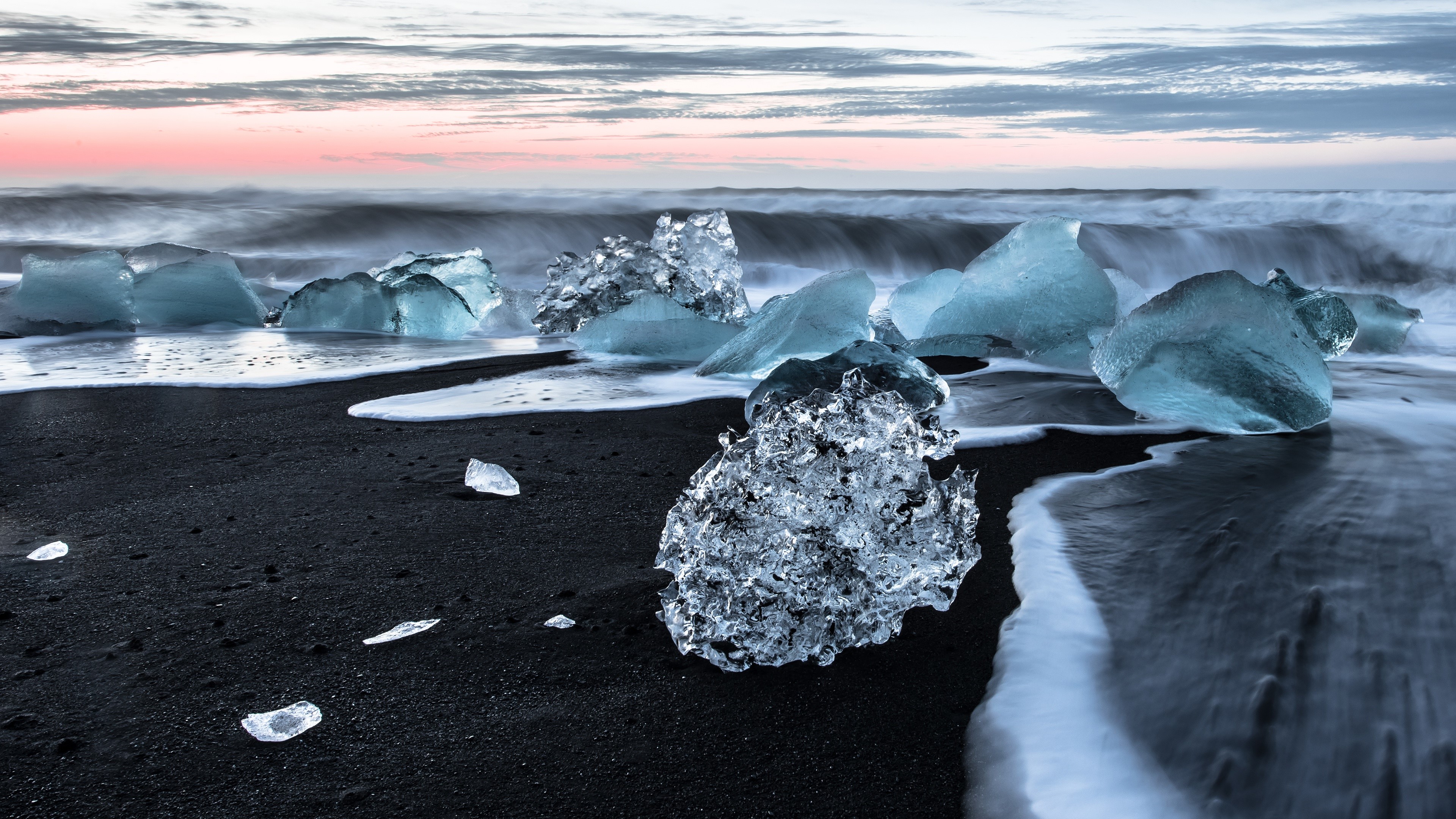 4K ice on black sand beach with ocean waves HD Wallpaper