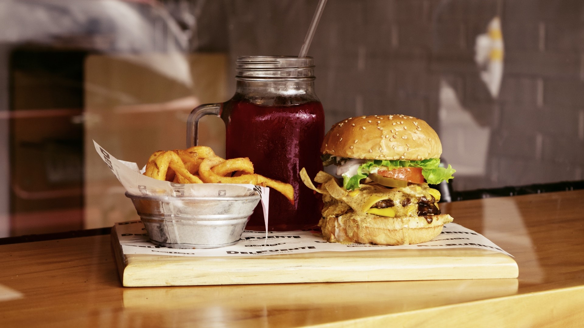 Burger, curly fries, and drink on a wooden board HD Wallpaper