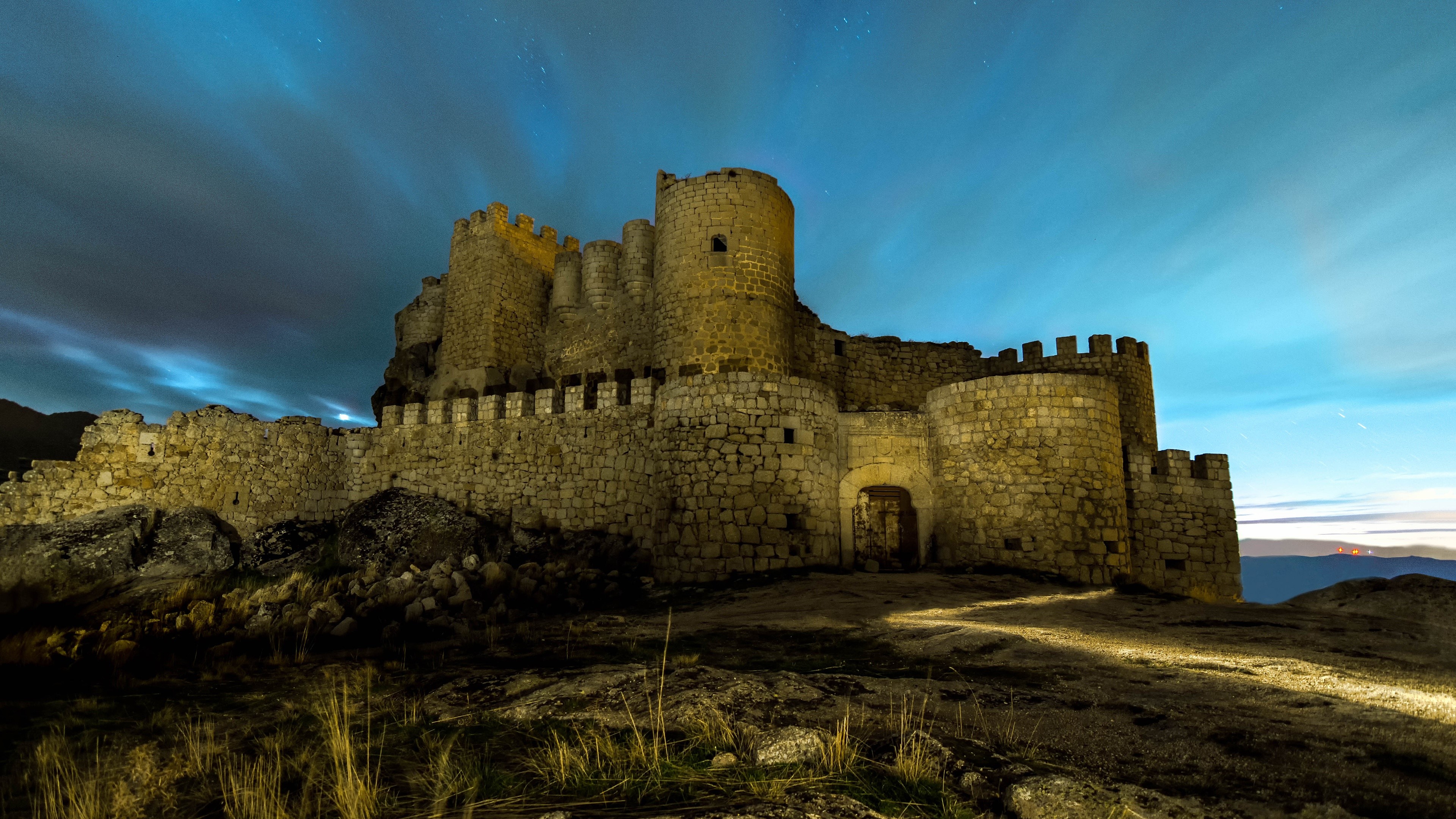 Castle ruins at night under a starry sky HD Wallpaper