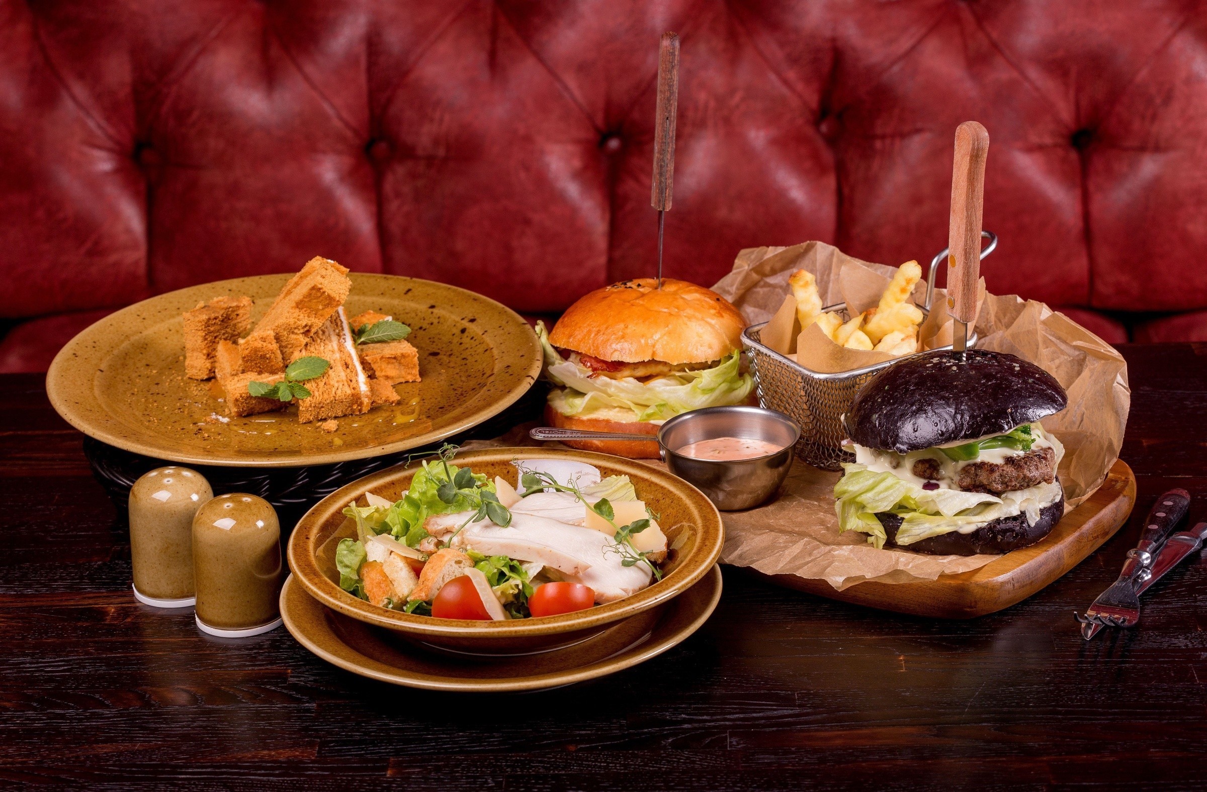 Burgers, fries, salad, and dessert on a table HD Wallpaper
