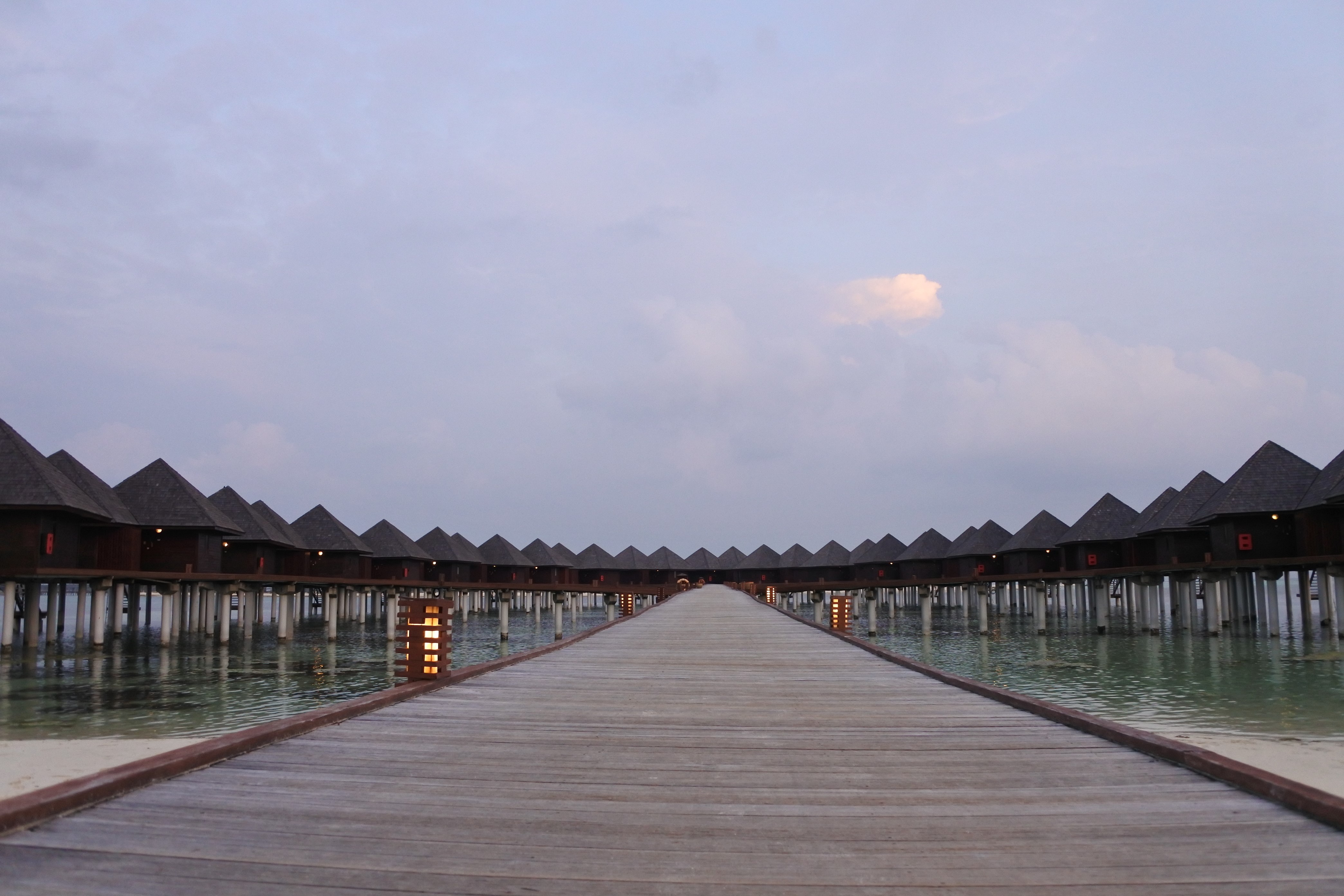 Symmetry of overwater bungalows on a pier HD Wallpaper